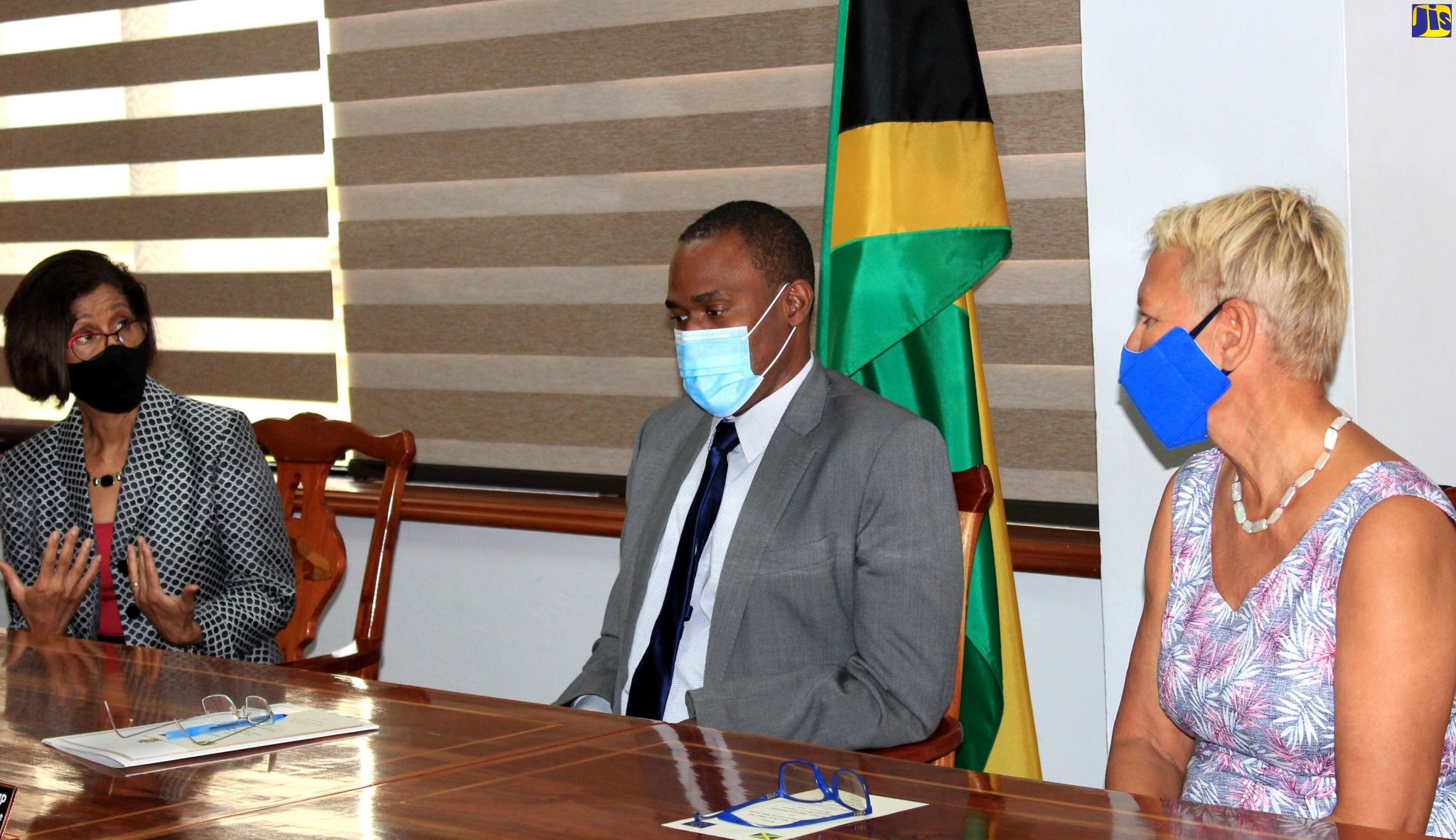Minister of Finance and the Public Service, Dr. the Hon. Nigel Clarke (centre), and outgoing Head of the European Union Delegation to Jamaica, Belize, The Bahamas, Turks & Caicos Islands, and Cayman Islands, Ambassador Malgorzata Wasilewska (right), in discussion with Permanent Secretary in the Ministry of Justice, Sancia Bennett-Templer, during a courtesy call and brief ceremony at the Finance Ministry’s offices in Kingston, on Friday (September 11), for the formal handover of the EU-funded Jamaica Justice Sector Reform Programme to the Government.