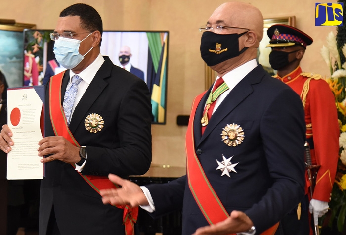 Prime Minister, the Most Hon. Andrew Holness (left), proudly displays his Instrument of Appointment during his swearing-in ceremony at King's house on Monday (September 7). Beside him is Governor General, His Excellency the Most Hon. Sir Patrick Allen, who oversaw the process.