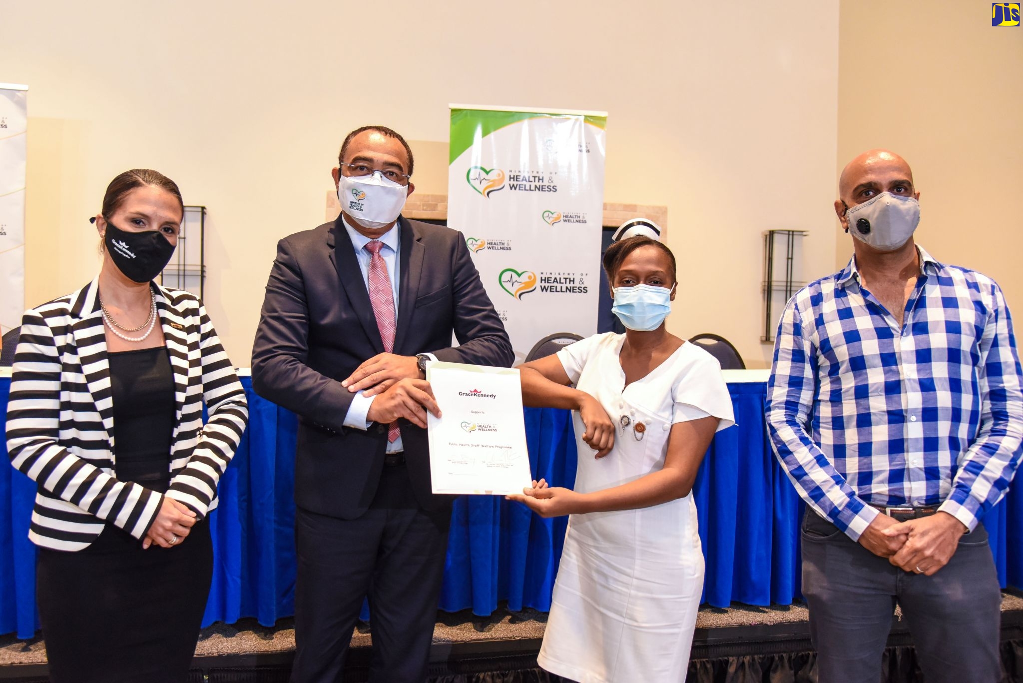 Minister of Health and Wellness, Dr. the Hon. Christopher Tufton (second left); and Registered Nurse, Antonia Richards-Stewart (second right), display document signifying GraceKennedy’s support to the Ministry’s public-health staff-welfare programme, during the official launch of the initiative at The Jamaica Pegasus hotel in New Kingston, on October 6. Also sharing the moment are Head of Corporate Communication, GraceKennedy, Suzanne Stanley; and Executive Director, Chukka Caribbean, John Byles. GraceKennedy and Chukka Caribbean have committed to supporting the Ministry’s undertaking.