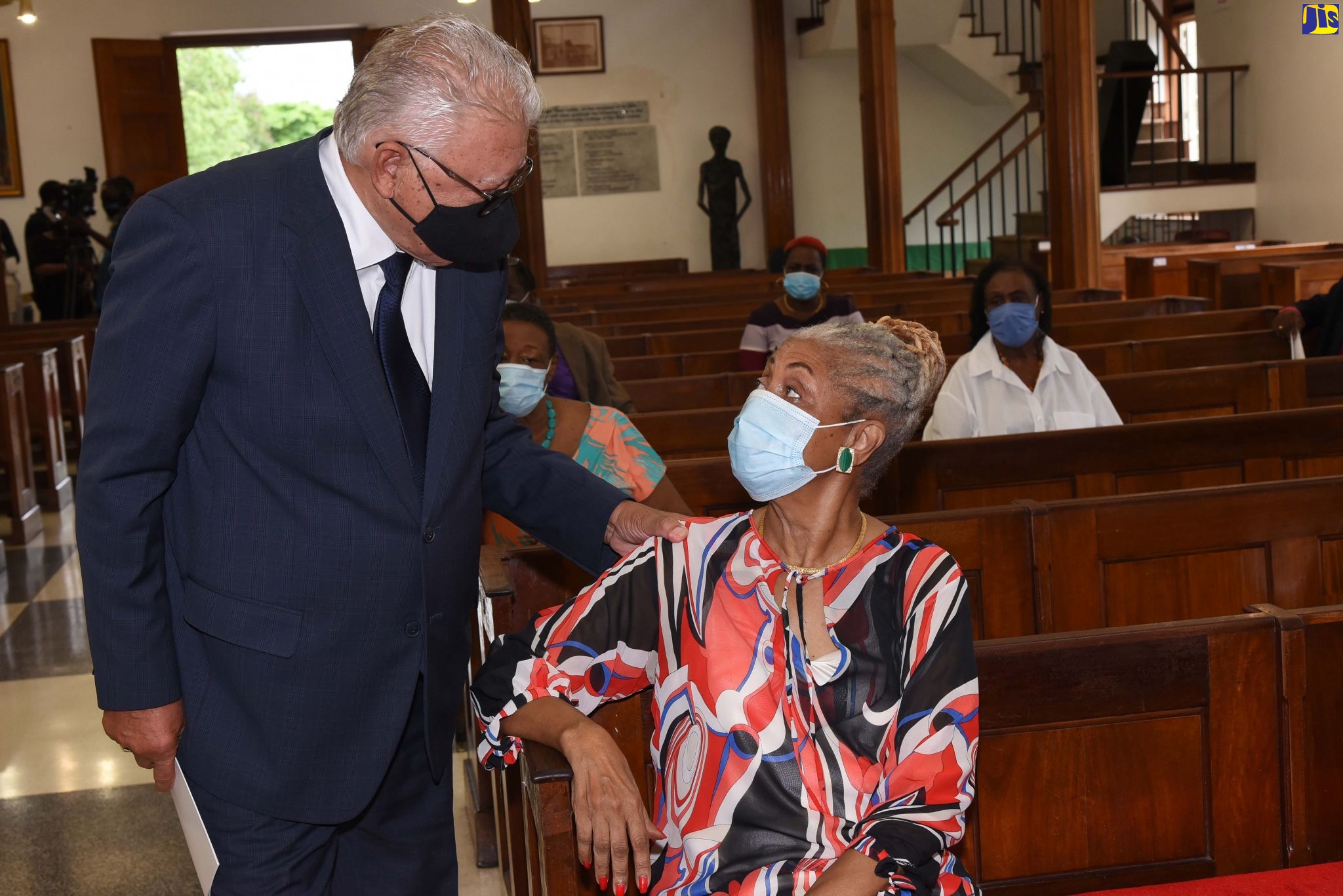 Minister of Labour and Social Security, Hon. Karl Samuda (left), greets Beverly Duncan, widow of the late former Cabinet Minister and Member of Parliament, Dr. D.K. Duncan, at his official memorial held on Sunday, October 25, at the University Chapel in St. Andrew.