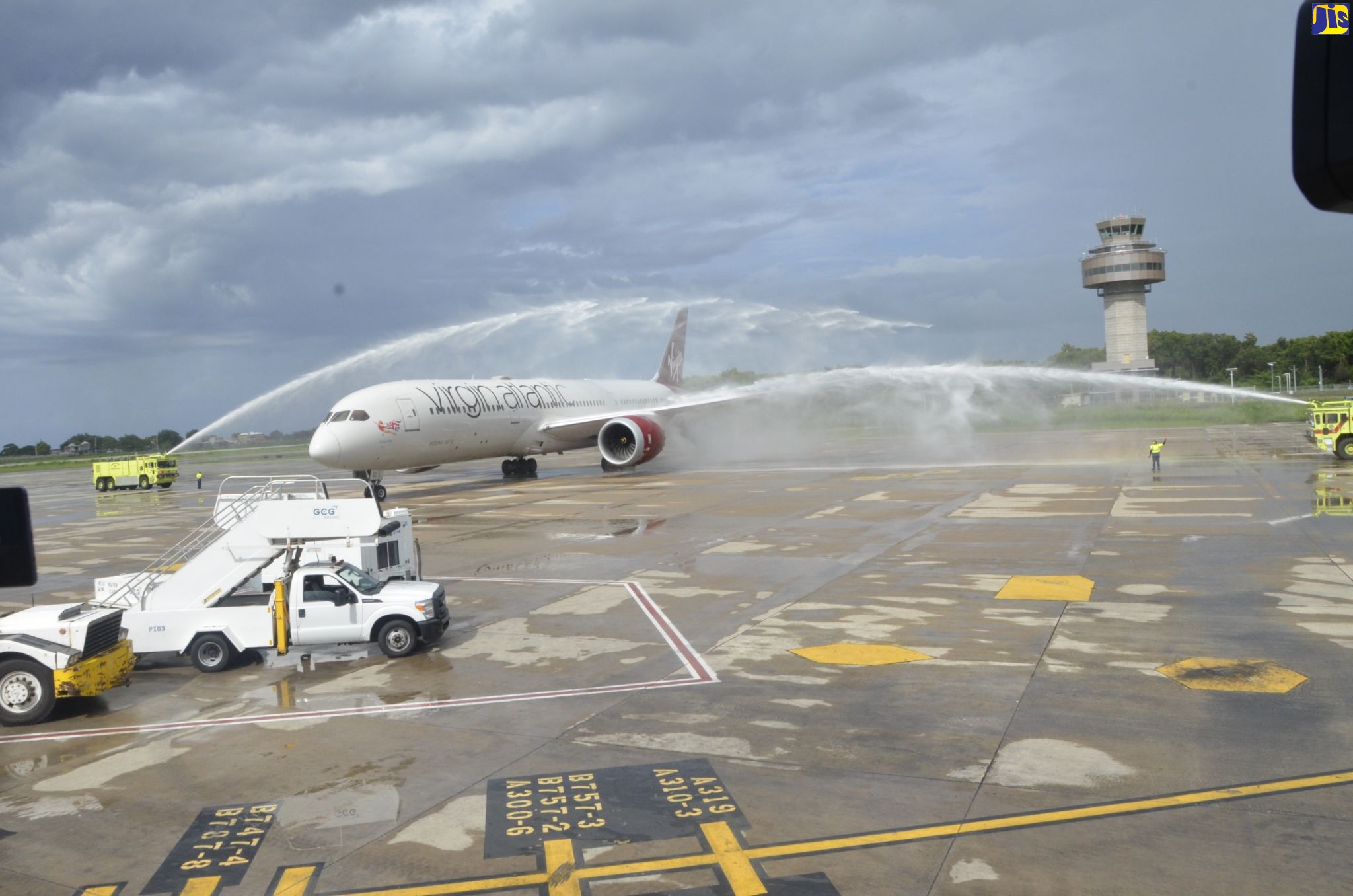 The Virgin Atlantic plane carrying passengers and crew from London, England, taxis beneath the symbolic water salute at the Sangster International Airport in Montego Bay, St. James, as the airline resumed flights to the island on October 2.