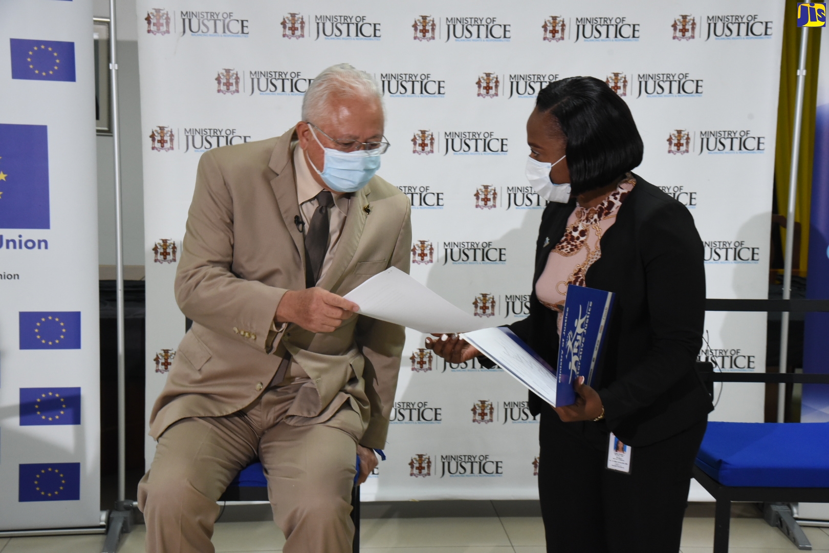 Minister of Justice, Hon. Delroy Chuck (left), consults with Coordinator, Restorative Justice, Ministry of Justice, Adrienne Lindsay, during the Access to Justice Virtual Town Hall Meeting, on October 21.