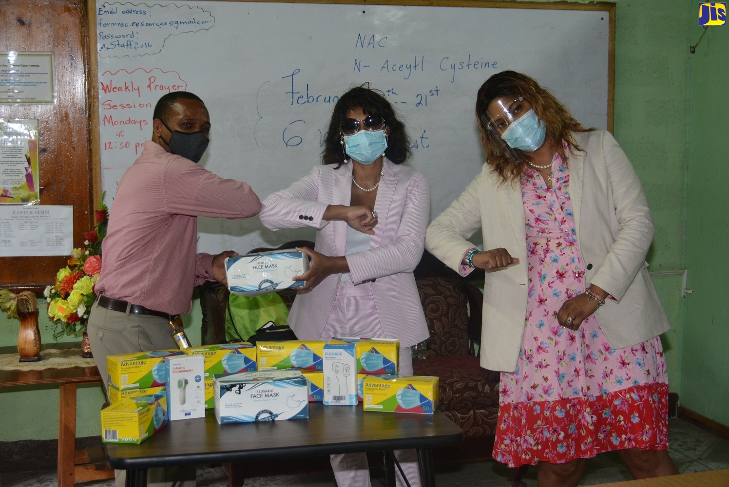 Principal of Farm Primary and Infant School, Richard Miller (left), accepts personal protective equipment (PPE) against COVID-19 from Executive Director of Children of the Caribbean Foundation, Rosie Hodge-Adams (centre), and Community Development Director of Children of the Caribbean Foundation, Rochelle Jefferson-Carey, during a special handover ceremony, held on the school compound in Green Pond, St. James, on October 5.