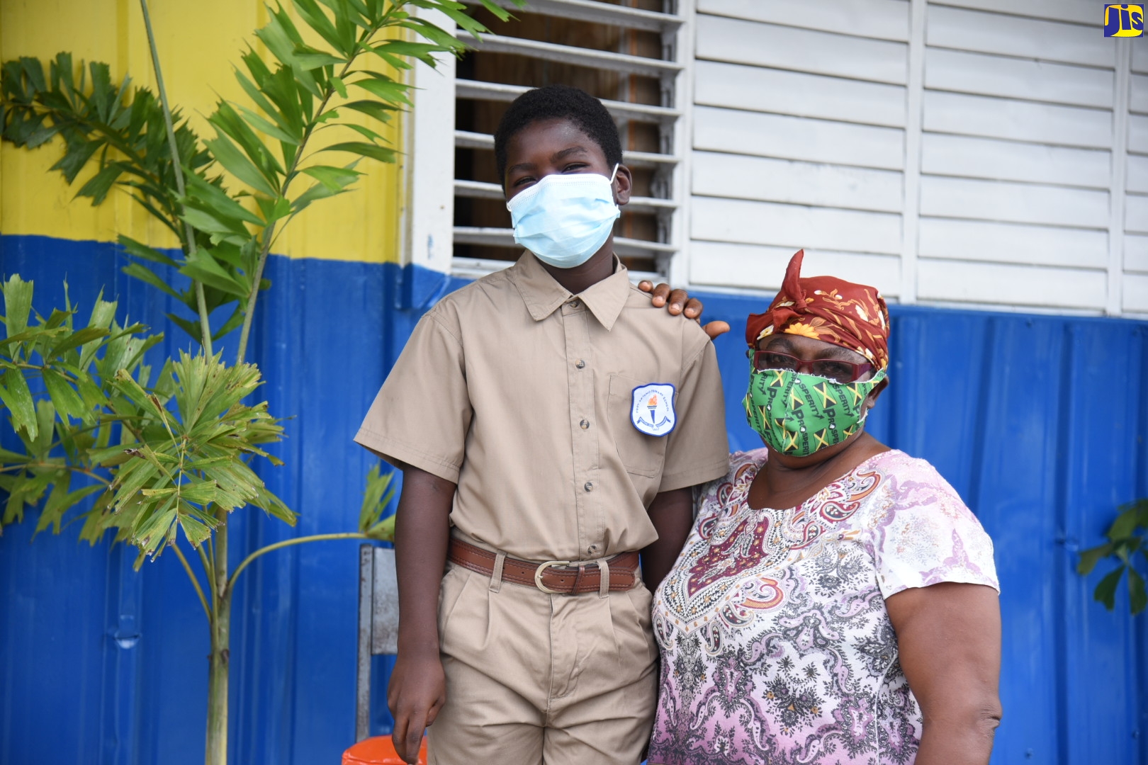Daureen Thompson with her grandson, Kedron Gayle, at the Port Antonio Primary School in Portland on October 22, where devices were handed over to students under the Tablets in Schools programme. 