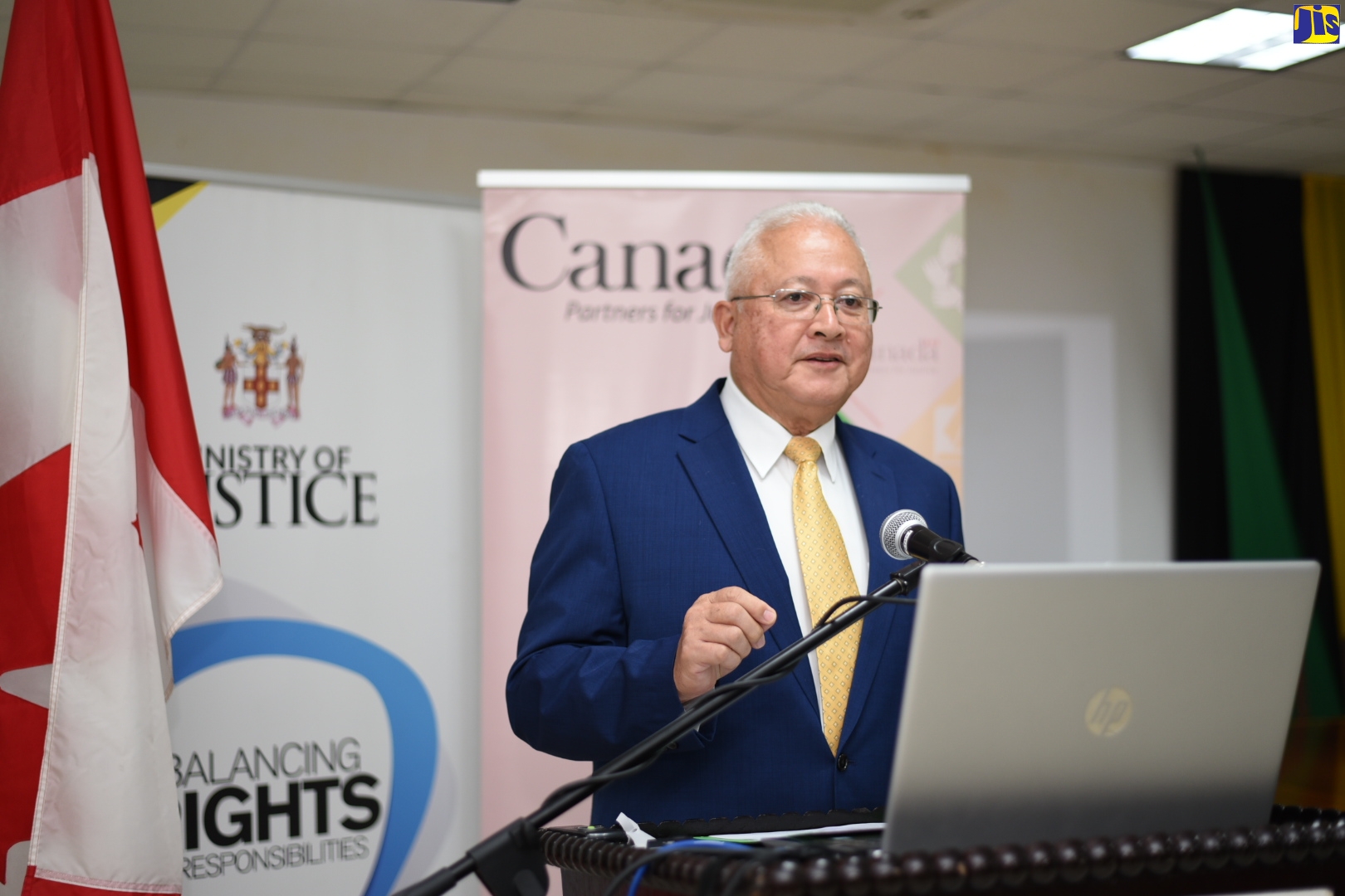 Minister of Justice, Hon. Delroy Chuck, addresses a ceremony for the handover of the Witness Care Strategy and Action Plan to stakeholders in the justice system, at the Ministry in Kingston on Wednesday (October 28).