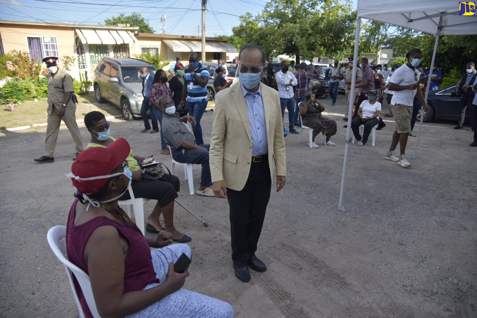Minister of National Security,  Hon. Dr. Horace Chang (right), speaks to a resident of Glendale, in Kingston 20, on Friday (September 25).