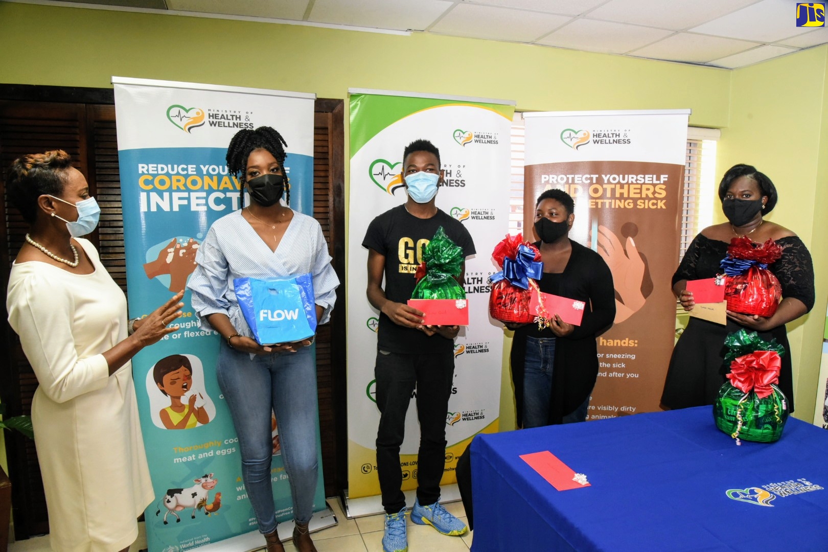 State Minister in the Ministry of Health and Wellness, Hon. Juliet Cuthbert-Flynn (left, congratulates the top competitors in the Ministry of Health and Wellness’ ‘COVID AH KIP’ social media competition at the awards ceremong held on Wednesday (October 7) at the Ministry
