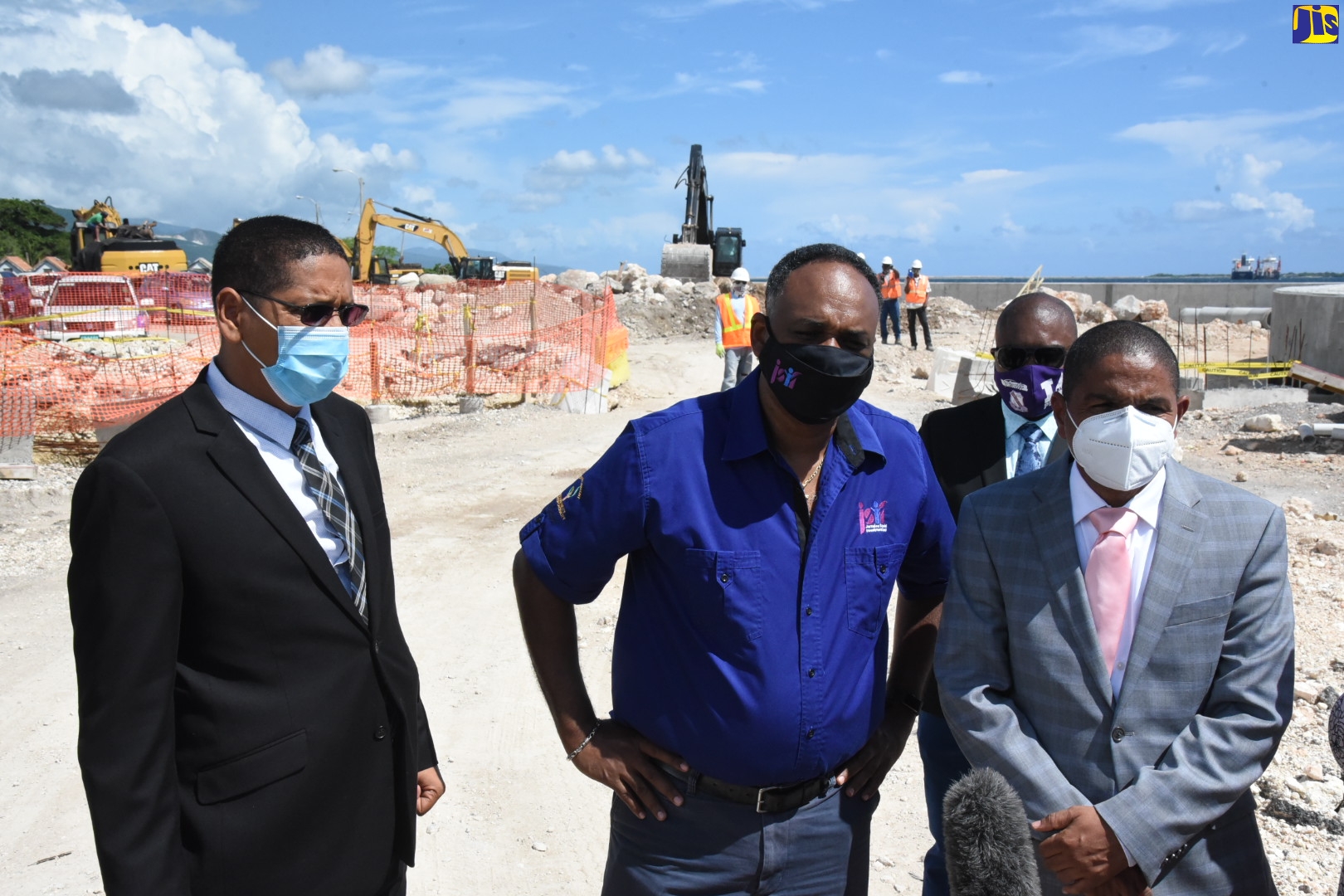 Managing Director, Jamaica Social Investment Fund (JSIF), Omar Sweeney (centre), addresses journalists during a tour of the Port Royal Street Coastal Revetment Project along Port Royal Street, downtown Kingston on Tuesday (September 29). Also on the tour are (from left) Member of Parliament for Central Kingston, Donovan Williams; Acting City Engineer, Kingston and St. Andrew Municipal Corporation (KSAMC), Xavier Chevannes;  and  Mayor of Kingston, Senator Councillor, Delroy Williams.
