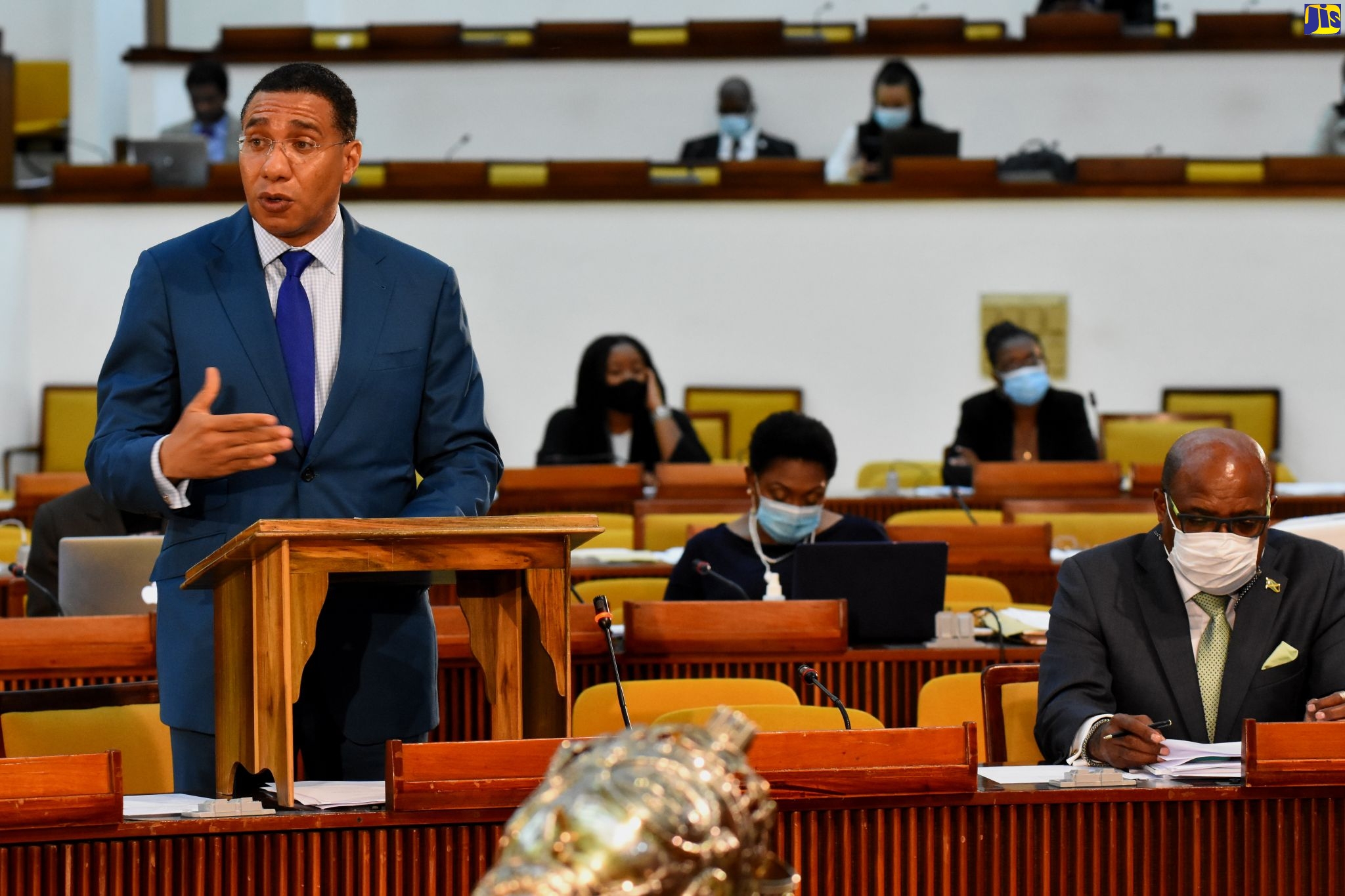 Prime Minister, the Most Hon. Andrew Holness (at lectern), highlights a point while making a statement regarding recent heavy flood rains, during the sitting of the House of Representatives on Tuesday (October 27). Also pictured (at right) is Minister of Tourism, Hon. Edmund Bartlett.
