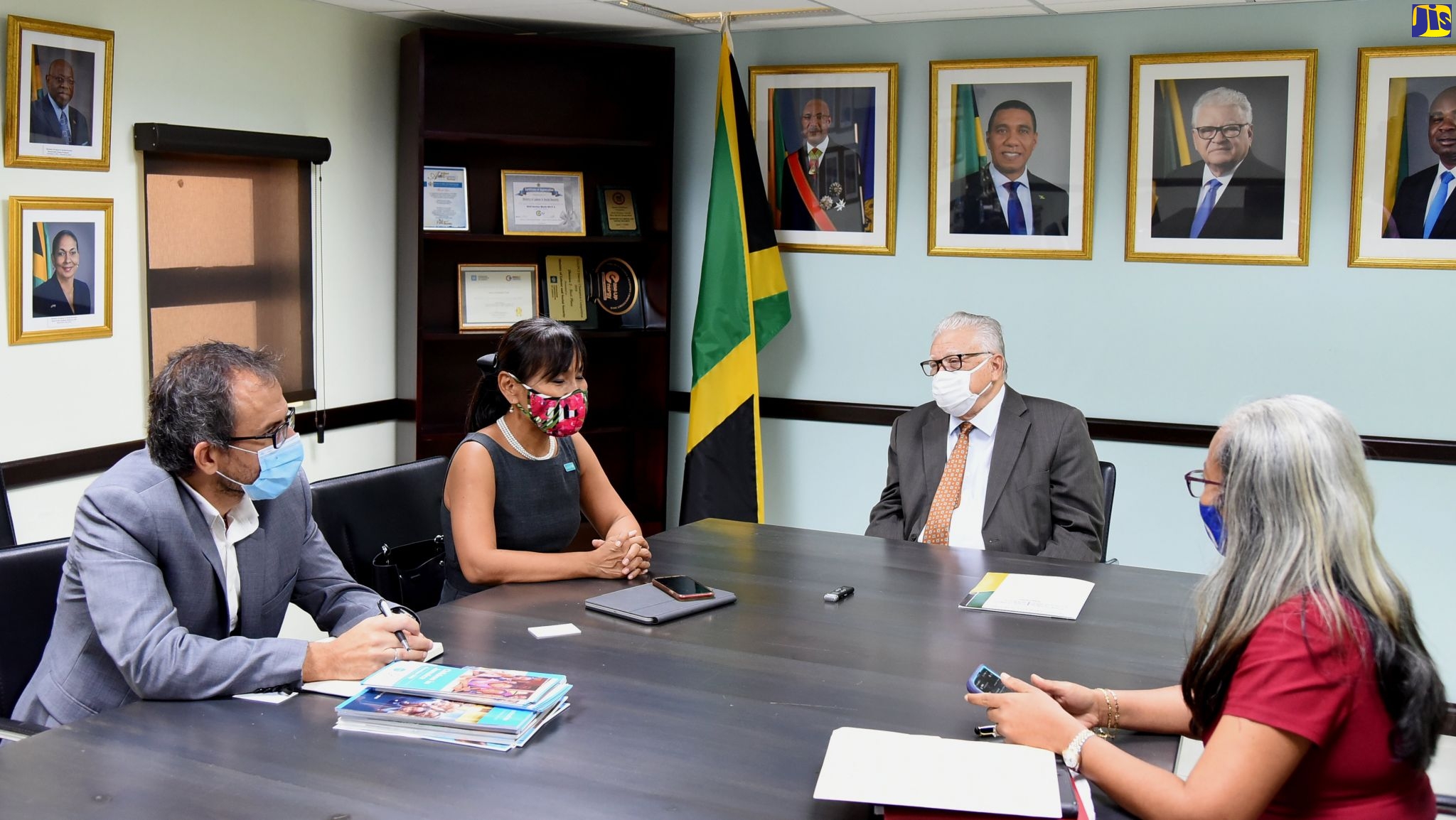  Minister of Labour and Social Security, Hon. Karl Samuda (second right) shares in conversation with (from left) United Nations Children