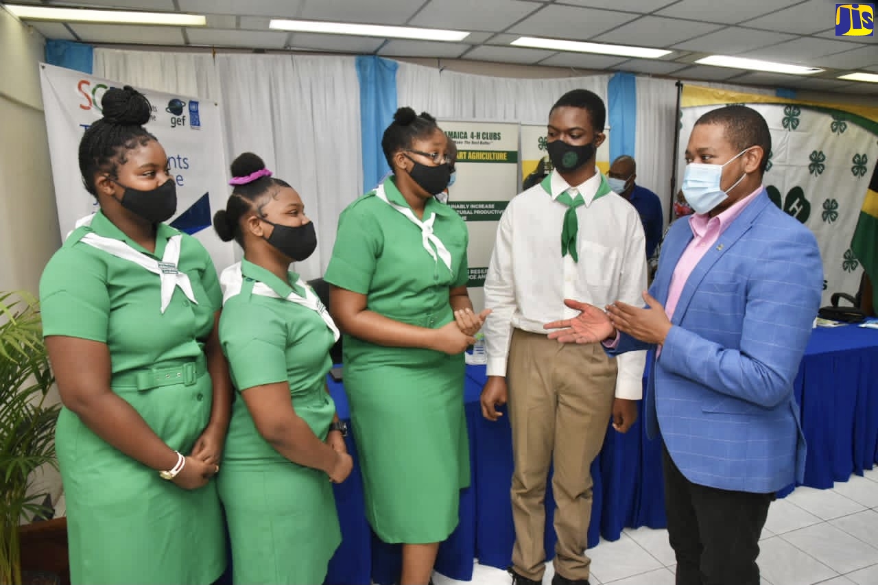 Minister of Agriculture and Fisheries, Hon. Floyd Green (right), interacts with 4-H clubbites from Kingston and St. Andrew, at the launch of the Youth in Agriculture Roadmap, on November 12, at the Ministry in Kingston.