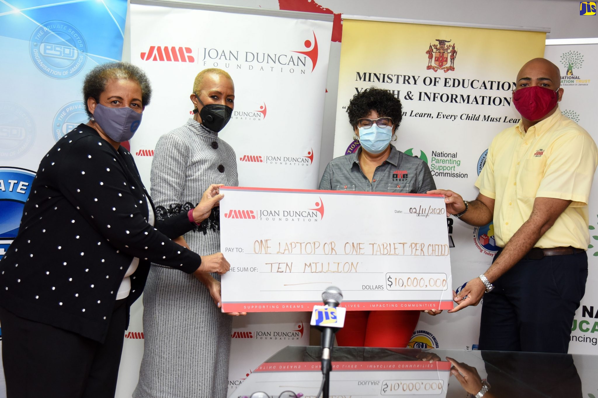 Minister of Education, Youth and Information, Hon. Fayval Williams (second left), is presented with a symbolic cheque in the sum of $10 million by JMMB-Joan Duncan Foundation Chair, Patricia Duncan Sutherland (second right); and Board Member, Gifford Rankine (right), for the Ministry’s ‘One Laptop or Tablet Per Child’ Initiative. The presentation was made at JMMB’s Corporate Office in New Kingston, on Tuesday (November 3). Sharing the moment is Private Sector Organisation of Jamaica (PSOJ) Interim Chief Executive Officer, Greta Bogues.