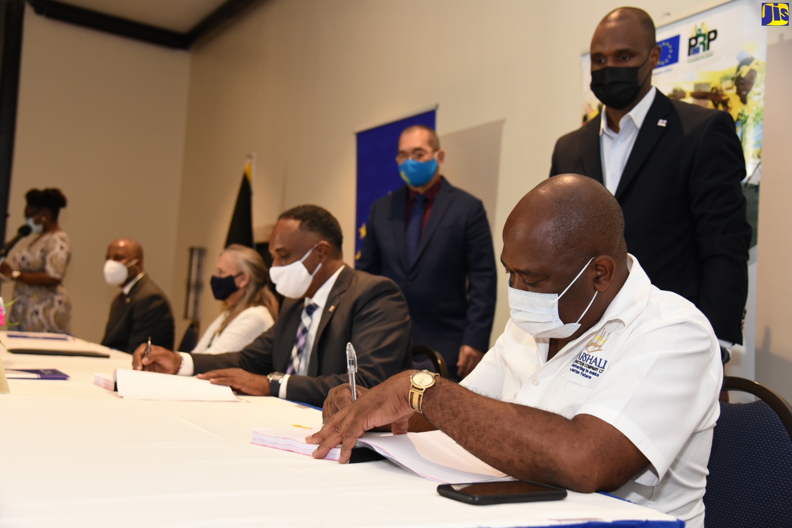 Chairman, Jamaica Social Investment Fund (JSIF), Dr. Wayne Henry  (left), and Head of the European Union Delegation to Jamaica,  Ambassador Marianne Van Steen (second left), at the ceremony where Managing Director, JSIF, Omar Sweeney (second right); and Director and Chief Executive Officer, Marshall Construction Company Limited, Alphanso Reynolds (right), sign a contract for the implementation of  major infrastructural sub-projects, under the Jamaica Social Investment Fund – Poverty Reduction Programme (PRP) phase four initiative. The signing ceremony was held at The Jamaica Pegasus hotel on November 19. Witnessing (from left) are General Manager, Finance and Procurement, JSIF, Orville Hill; and Senior Manager, Standards & Procurement, JSIF, Dwight Ricketts.

 