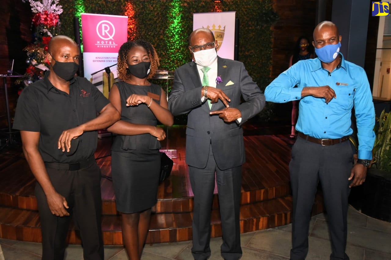 Minister of Tourism, Hon. Edmund Bartlett (second right), knocks elbows with Ambassadors for the Jamaica Hotel and Tourist Association’s COVID-19 Ambassador Programme (from left), House Manager, S Hotel, Andrew Thomas; Operations Lead Guest Agent, Altamont Court Hotel, Krystal Francis; and Bellman, R Hotel, Michael Ashman, at the R Hotel in Kingston after the launch of the programme, on Tuesday (November 24).