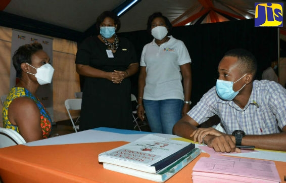 State Minister in the Ministry of Health and Wellness, Hon. Juliet Cuthbert Flynn (left), in conversation with Records Clerk, the National Blood Transfusion Services (NBTS), Gregory McHargh (right), at a blood drive organised by the National Blood Transfusion Services (NBTS), in partnership with Massy United Insurance Limited, on Friday (November 6), at Pan Jam Investment Limited courtyard, in Kingston. Also at the event are Acting Director, National Blood Transfusion Services (NBTS), Dr. Alisha Tucker (second left); and Branch Manager, Jamaica, Massy United Insurance Limited, Winsome Gibbs.