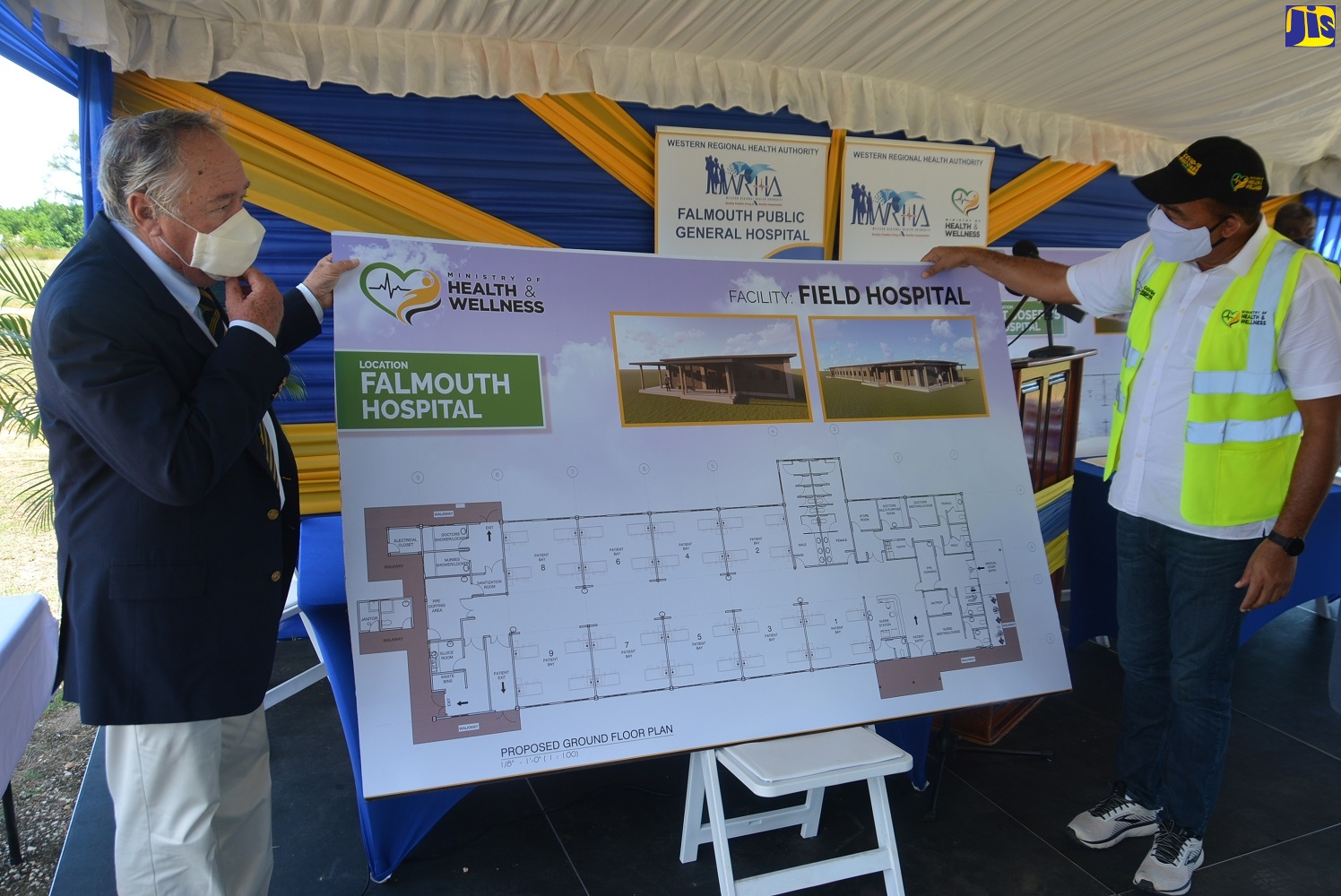 Minister of Health and Wellness, Dr. the Hon. Christopher Tufton (right); and Custos of Trelawny, Hon. Paul Muschett, looking at the design plans for the field hospital being constructed at the Falmouth Public General Hospital in Trelawny, when they attended the ground-breaking and contract signing on September 25.