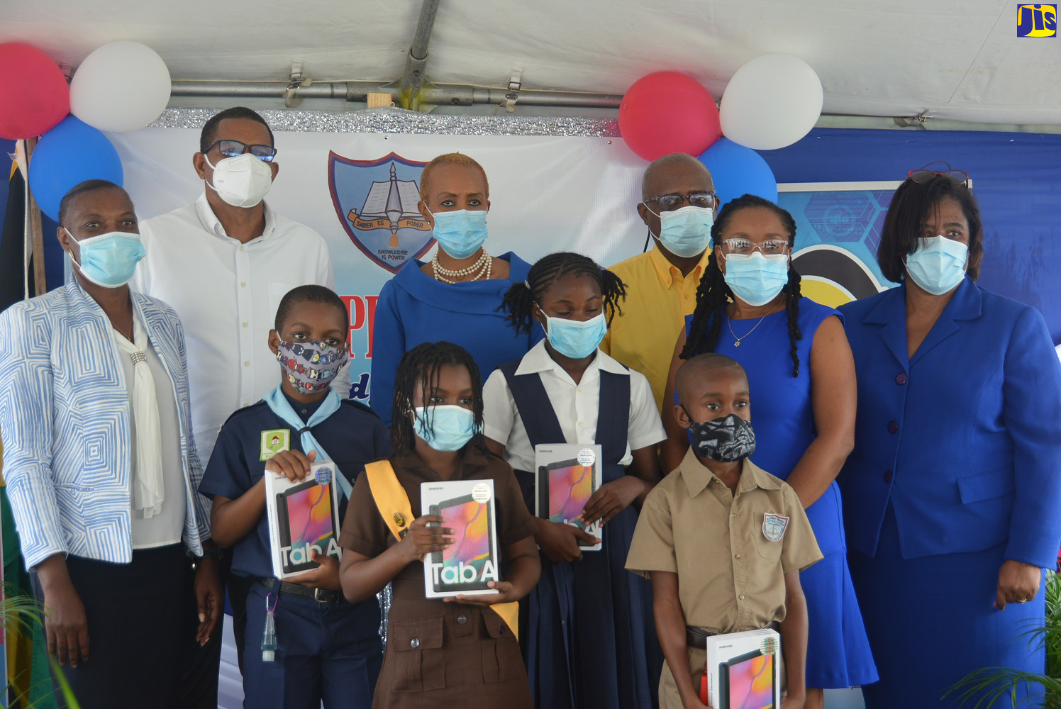 Education, Youth and Information Minister, Hon. Fayval Williams (back, third left), is joined by staff and students of Sandy Bay Primary & Junior High School in Hanover, during a ceremony for the presentation of  99 tablets  to students of the institution on Thursday (November 19), under the Government’s Tablets in Schools Programme.