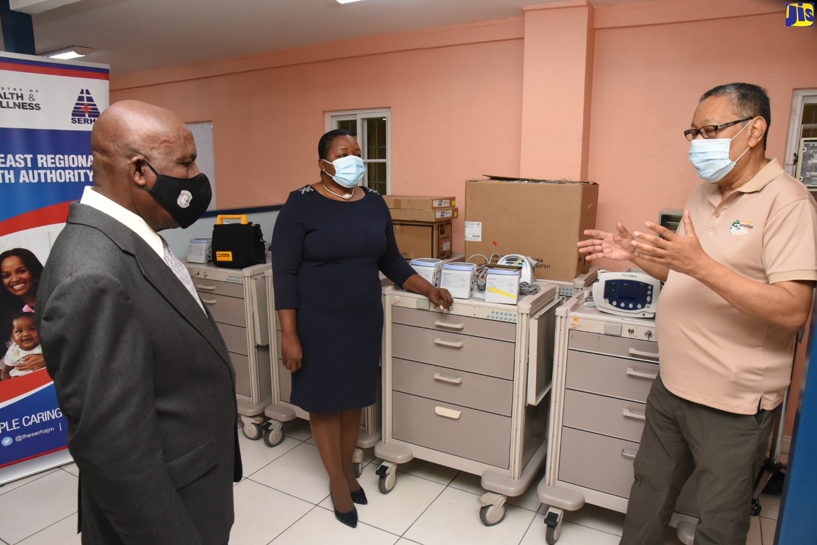 Director of the Good Samaritan Inn (GSI) and the GSI Foundation, Gavin Lowe (right), converses with Chairman of the charity, Dr. Eric Nathan (left); and Regional Director, South East Regional Health Authority (SERHA), Maureen Golding, during the handover of medical equipment to SERHA on Tuesday (November 3), at the GSI
