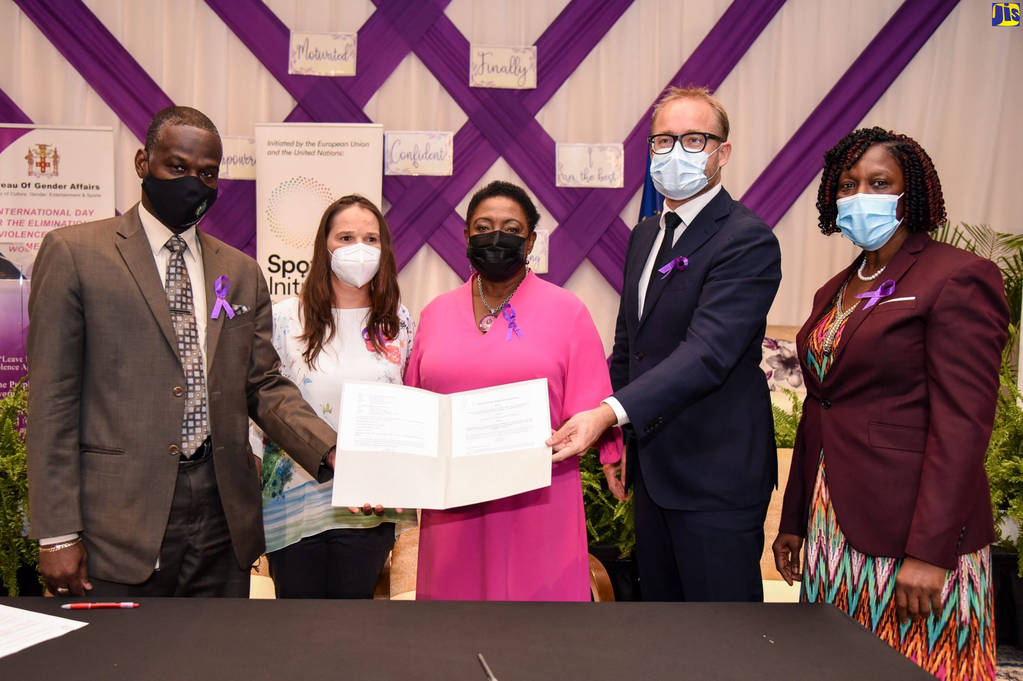 Minister of Culture, Gender, Entertainment and Sport, Hon. Olivia Grange (centre), displays signed implementing partnership agreement between the Ministry (Bureau of Gender Affairs) and the United Nations Population Fund (UNFPA), at The Jamaica Pegasus hotel in Kingston, on Wednesday (November 25). The agreement forms part of local efforts to eradicate violence against women and girls. With the Minister (from left) are Permanent Secretary in the Ministry, Denzil Thorpe; Gender Based Violence Specialist, UNFPA, Elga Salvador; Minister Counsellor/Deputy Head of the European Delegation, Frederik Ekfeldt; and Principal Director, Gender Affairs, Sharon Coburn Robinson. Occasion was the observance of International Day for the Elimination of Violence Against Women (IDEVAW) to mark the launch of 16 days of activism against gender-based violence.