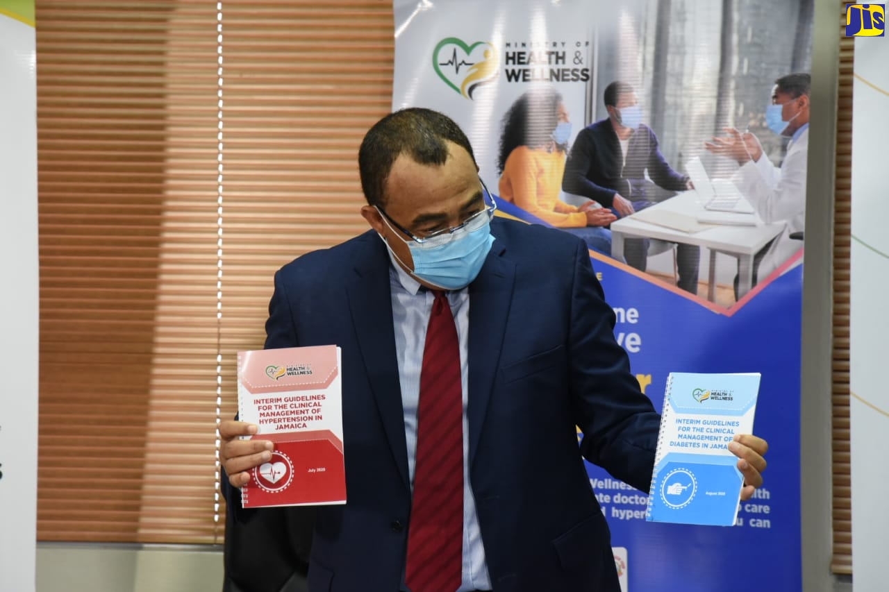 Health and Wellness Minister, Dr. the Hon. Christopher Tufton, displays interim guidelines for the clinical management of diabetes in Jamaica, during the virtual launch of the Public-Private Partnership for Non-Communicable Diseases (NCDs) pilot programme, on Tuesday (November 17). The programme seeks to maintain essential primary care services for non-coronavirus (COVID- 19) clients with diabetes and hypertension seeking treatment in the public health sector.