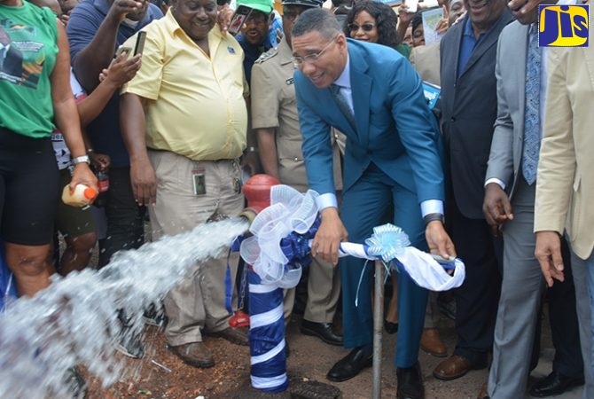Andrew Holness: Prime Minister, the Most Hon. Andrew Holness (foreground), turns on the main water valve to officially commission the Essex Valley Water Supply Project in St. Elizabeth in October 2019.

