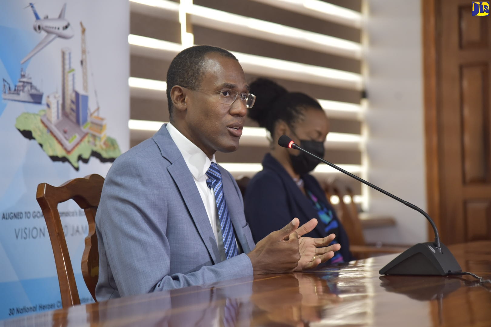 Minister of Finance and the Public Service, Dr. the Hon. Nigel Clarke, responds to questions from journalists during a media briefing at the Ministry, on Thursday (December 10). Beside him is Minister of State in the Finance Ministry, Hon. Marsha Smith.