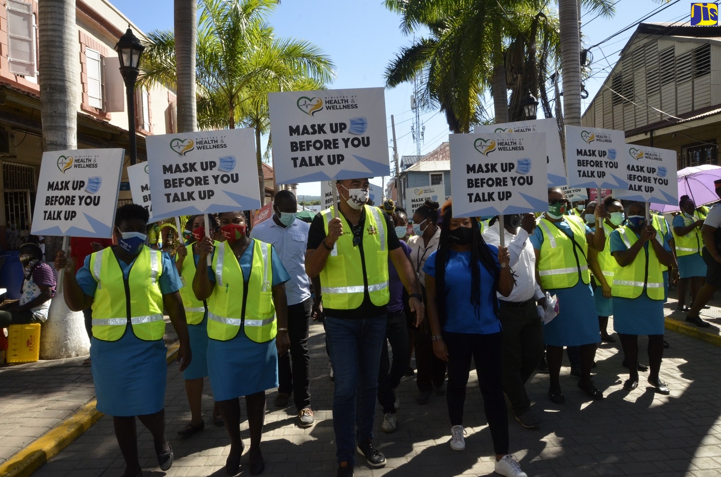 Minister of Health and Wellness, Dr. the Hon. Christopher Tufton (centre), leads a team of health workers through the town of Falmouth, Trelawny, on Thursday (December 17), as part of the ‘Mask Up Before You Talk Up’ coronavirus (COVID-19) sensitisation campaign.