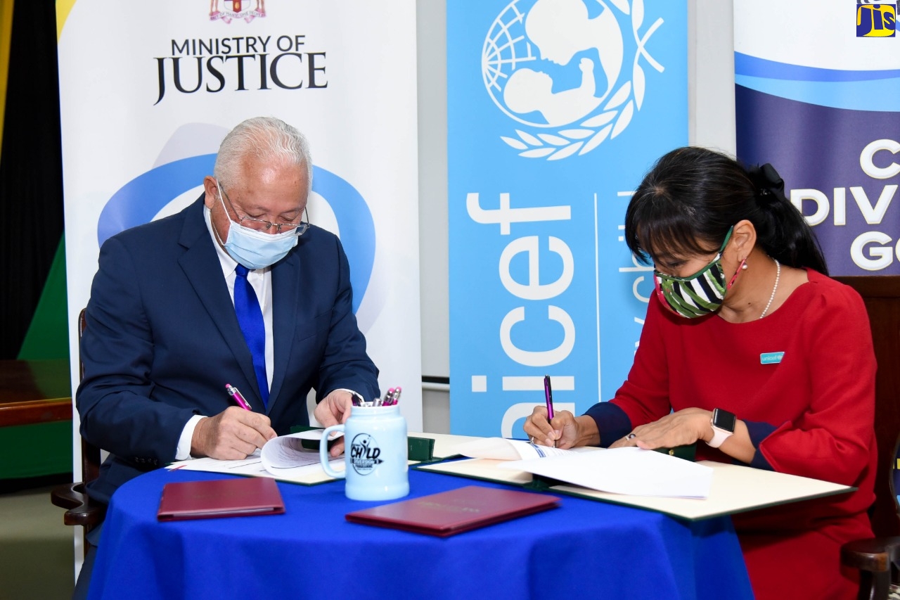 Justice Minister, Delroy Chuck, signs a $10-million Memorandum of Understanding (MOU) with UNICEF Country Representative, Mariko Kagoshima, today (December 9), at the Ministry