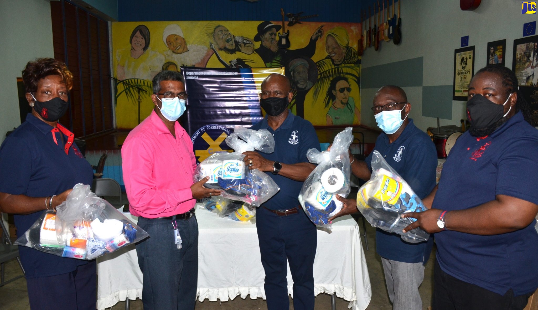 Custos of Kingston, Hon. Steadman Fuller (centre), presents Superintendent A at the Tower Street Adult Correctional Centre, Ivan Randall (second left), with a care package for inmates at the facility.  Also pictured are members of the Lay Magistrates Association of Jamaica (LMAJ) Kingston chapter, (from left) Secretary, Dr. Paulette Francis-McGregor; President, Lt. Col. (Retd), Euken Mills; and Treasurer, Davel Bell. More than 200 packages were handed over for inmates at Tower Street and female wards at the South Camp Juvenile Remand and Correctional Centre by the LMAJ Kingston chapter, during separate ceremonies on Thursday (December 17).

