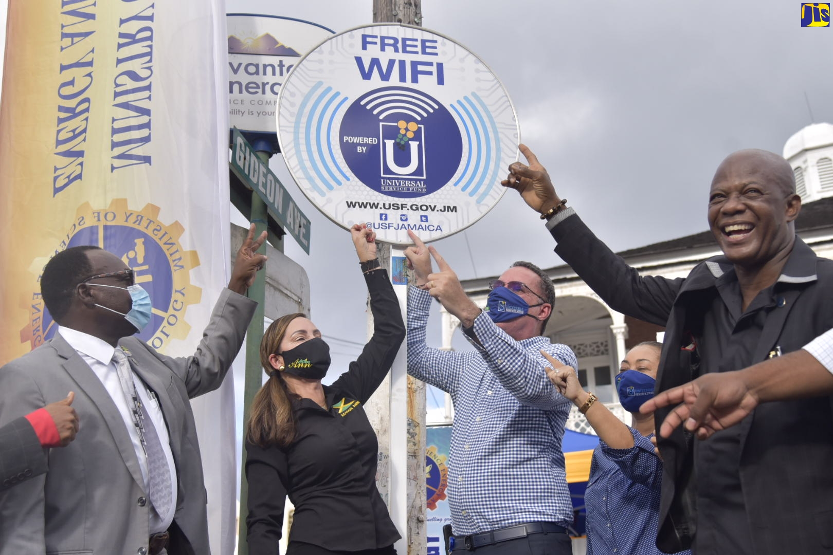 Minister of Science, Energy and Technology, Hon. Daryl Vaz (centre), points to the free public Wi-Fi sign which was unveiled for the service that has been established in Port Antonio. The internet hotspot was launched on December 11. Sharing the moment (from left) are: Port Antonio Mayor, Councillor Paul Thompson; Eastern Portland Member of Parliament, Ann-Marie Vaz; and Chief Executive Officer, Universal Service Fund (USF), Daniel Dawes.