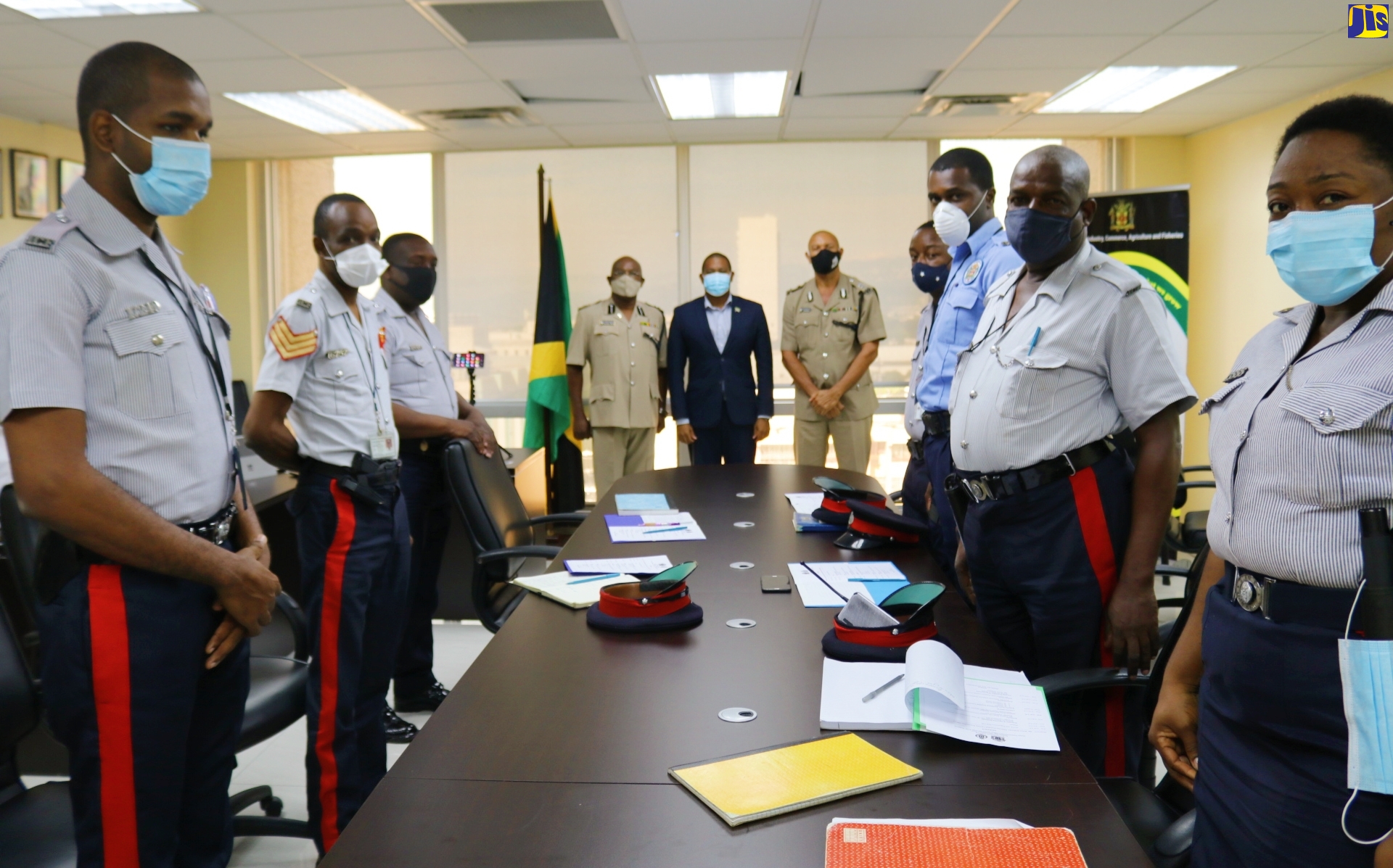 Agriculture and Fisheries Minister, Hon. Floyd Green (fifth left), with members of the Praedial Larceny Prevention Coordination Unit at the Anti-Praedial Larceny Pre-Christmas Training Programme held at the Jamaica Constabulary Force (JCF) Criminal Investigation Branch on Oxford Road, Kingston, on Wednesday (December 2).