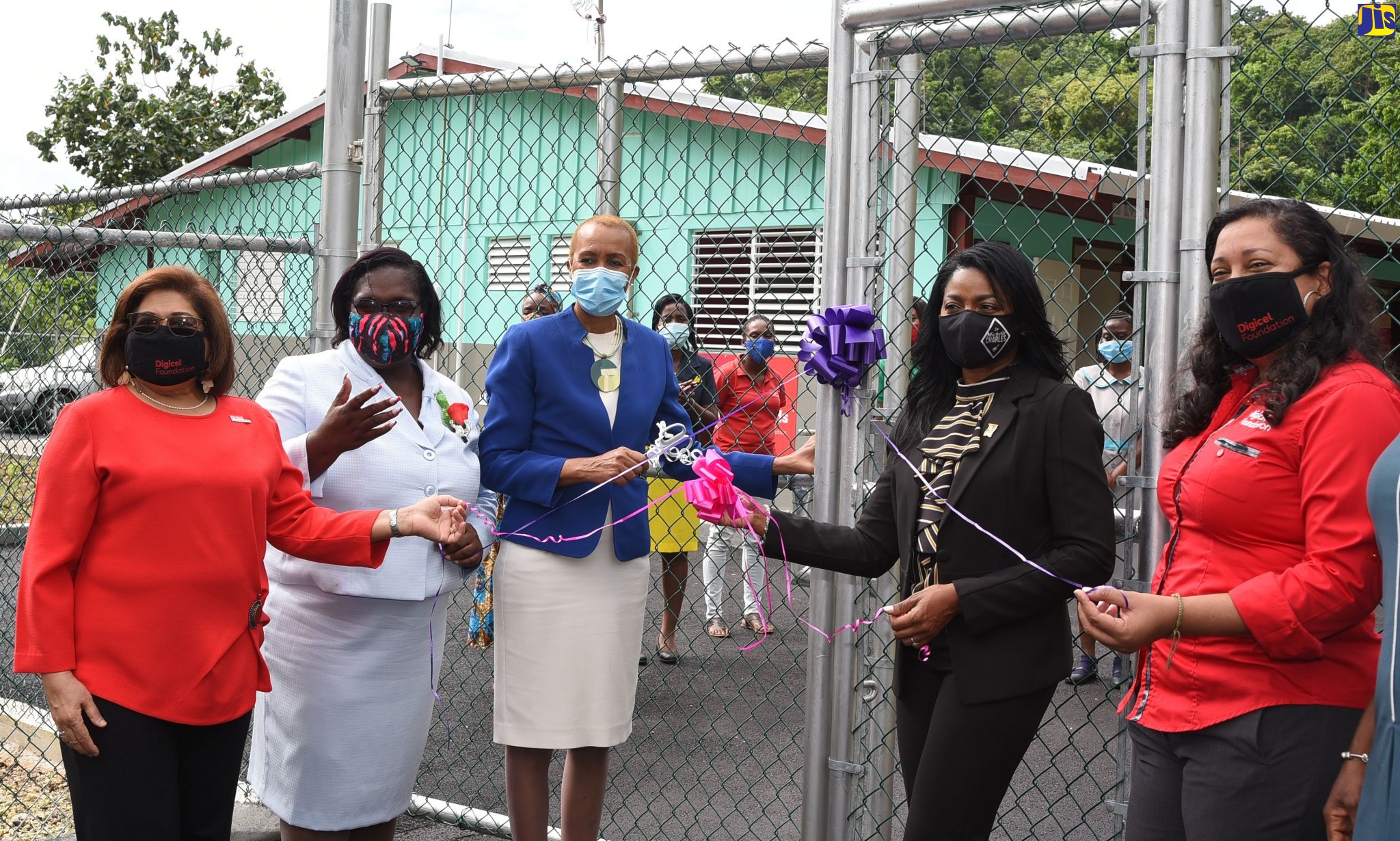 Minister of Education, Youth and Information, Hon. Fayval Williams (centre); and Member of Parliament for St. Thomas Eastern, Dr. Michelle Charles (second right), cut the ribbon to open the newly renovated Pear Tree River Special Needs School, formerly called Pear Tree Primary, in St. Thomas, on Wednesday (December 16). Also participating (from left) are Chairperson of the Digicel Foundation, Jean Lowrie-Chin; Acting Principal of Lyssons Centre of Excellence, Jacqueline Hendricks; and Chief Executive Officer of Digicel, Charmaine Daniels.