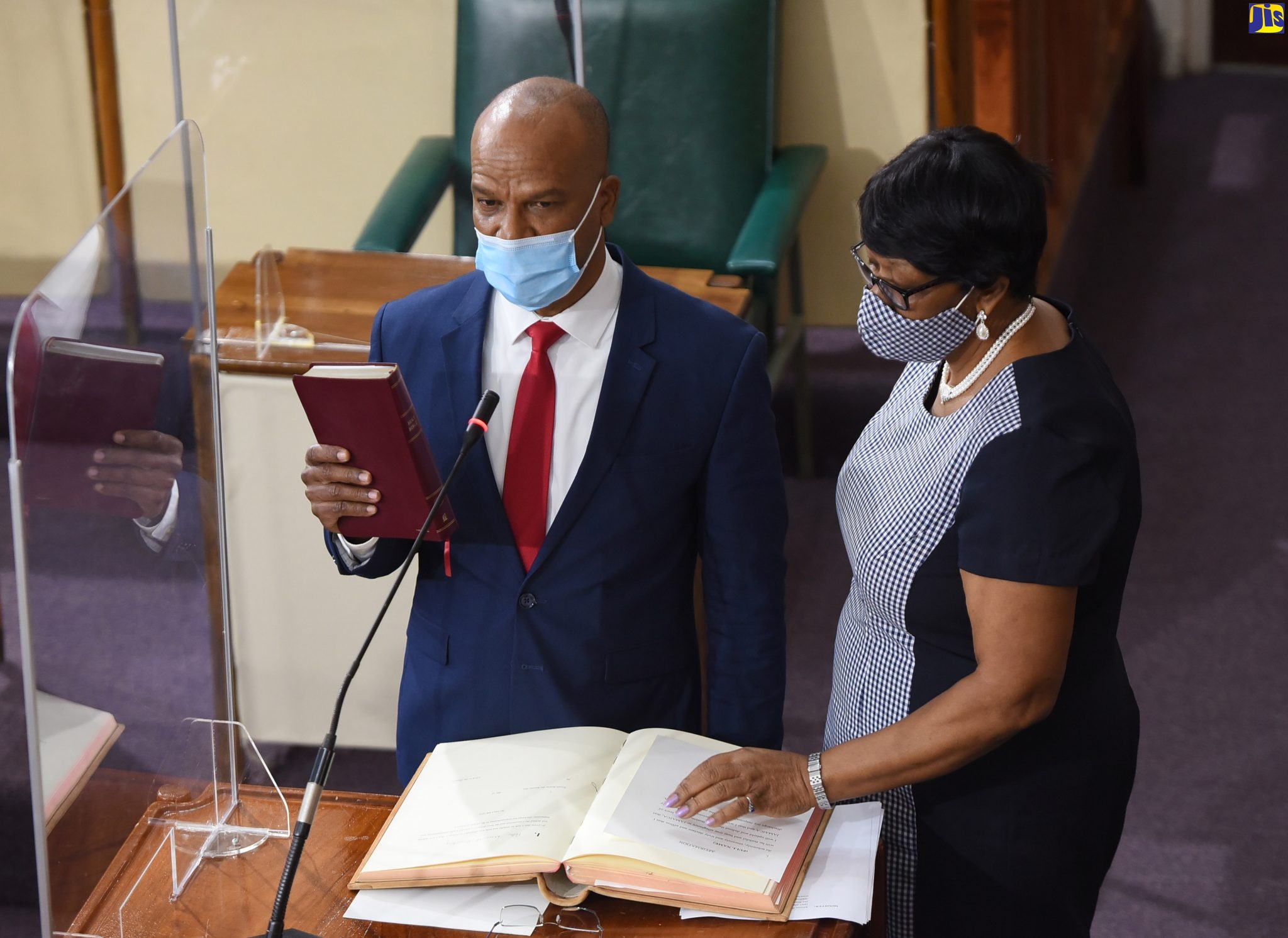Newly appointed Opposition Senator, Peter Bunting (left), takes the Oath of Allegiance during the swearing-in ceremony at Friday’s (December 18) sitting of the Senate at Gordon House. Administering the proceedings is Deputy Clerk to the Houses of Parliament, Valrie Curtis. Senator Bunting has also been appointed Leader of Opposition Business in the Upper House.