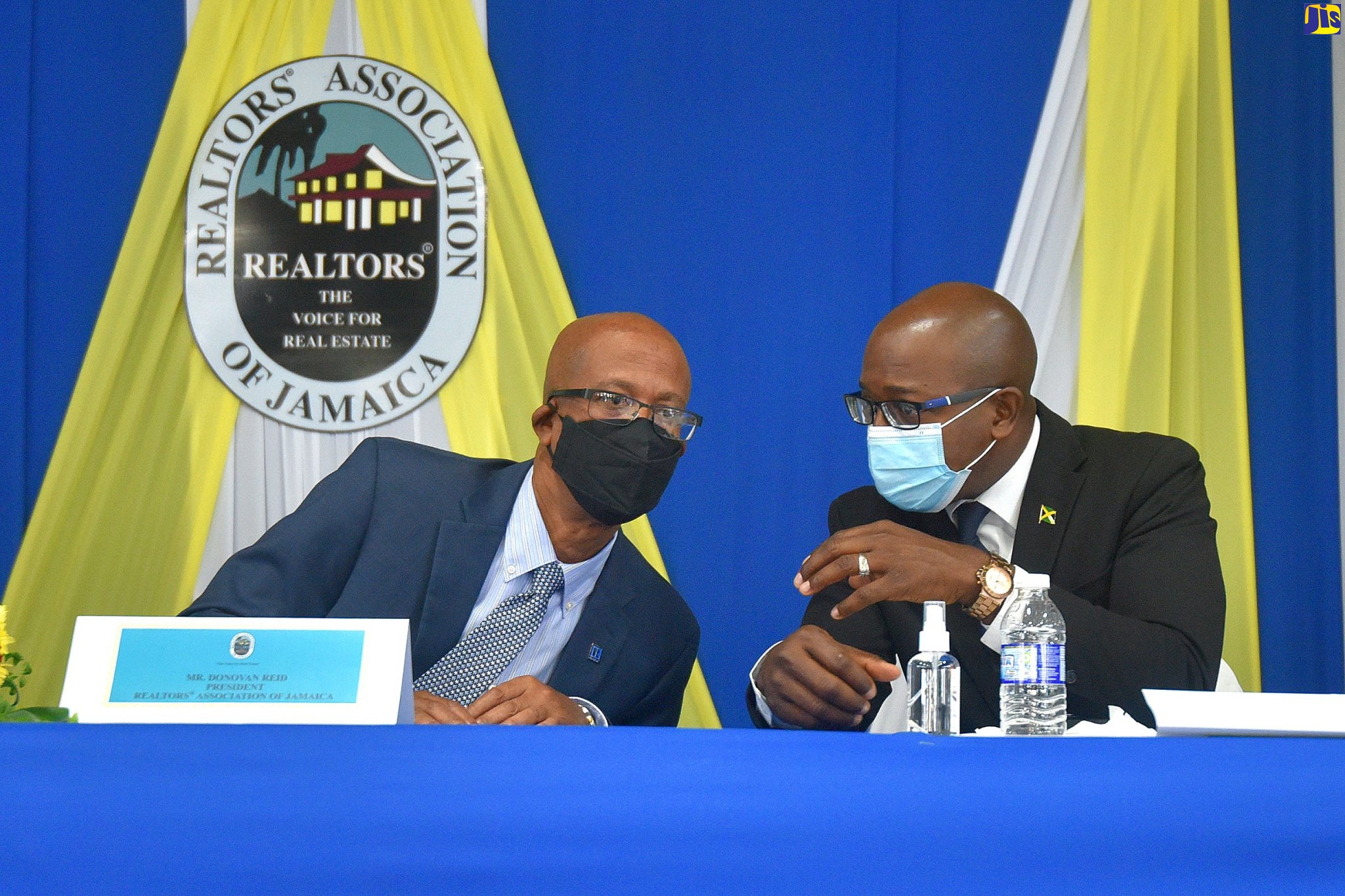 Minister of Housing, Urban Renewal, Environment and Climate Change, Hon Pearnel Charles Jr. (right), speaking with President of the Realtors Association of Jamaica, Donovan Reid (left), at the Association