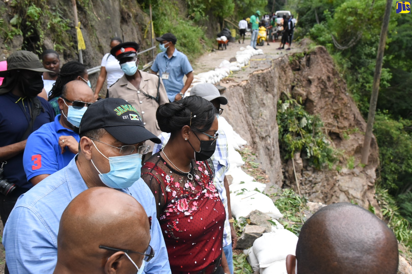 Prime Minister, the Most Hon. Andrew Holness (left), and Member of Parliament for St. Andrew East Rural, the Most Hon. Juliet Holness (right), view a major breakaway on the Gordon Town main road, today (December 5), during a tour of the area. With the Prime Minister are Minister without Portfolio in the Ministry of Economic Growth and Job Creation, Hon. Everald Warmington (left, background) and senior officials from the National Works Agency (NWA).
