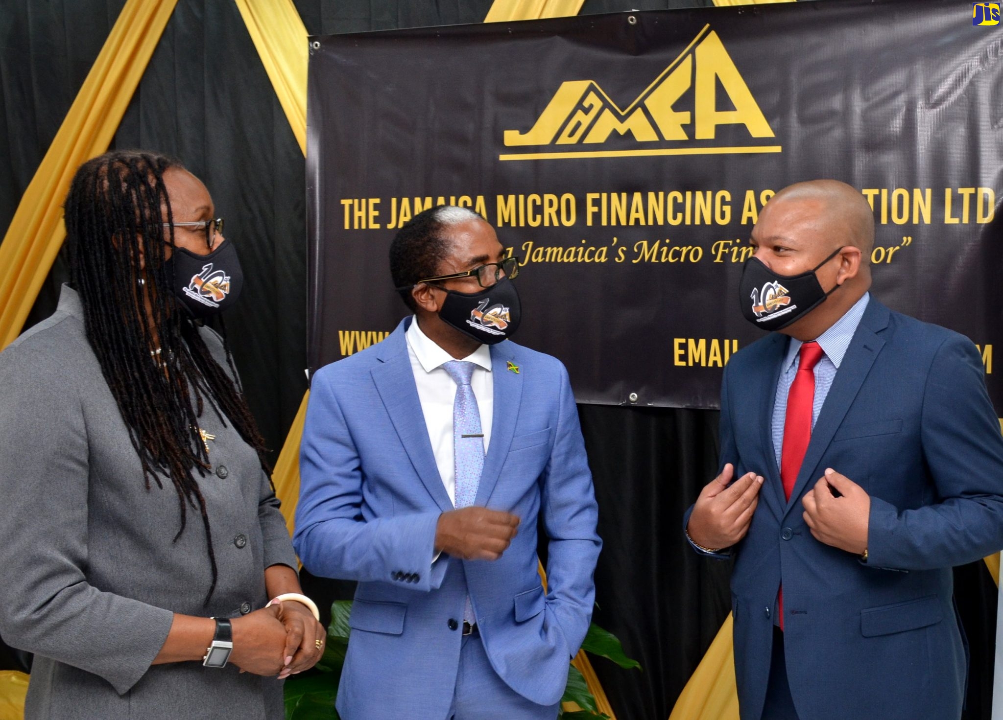 Minister of State in the Ministry of Industry, Investment and Commerce, Dr. the Hon. Norman Dunn (centre), shares in conversation with (from left) Outgoing Chairman, Jamaica Micro Financing Association (JaMFA), Sandra McDonald-Spence; and newly installed Chairman, JaMFA, Andrew Mais. The JaMFA hosted an installation ceremony for the incoming chairman at the Ministry’s New Kingston offices on December 10.
