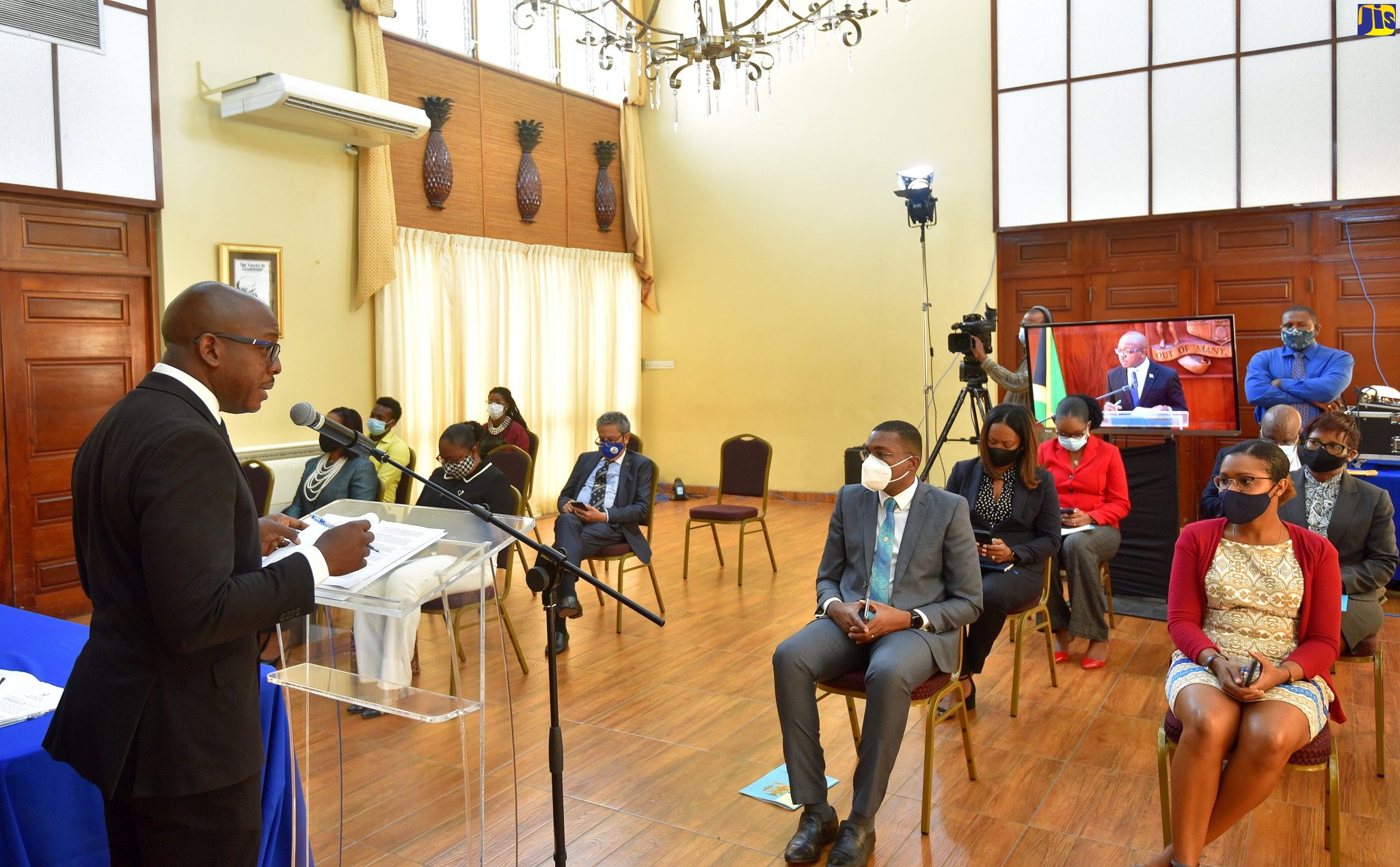 Minister of Housing, Urban Renewal, Environment and Climate Change, Hon. Pearnel Charles Jr. (left), addresses the small in-person audience at a virtual post-Cabinet press briefing on Wednesday (December 9). Also pictured in the front row (second right) is State Minister in the Ministry of Education, Youth and Information, Hon. Robert Morgan.