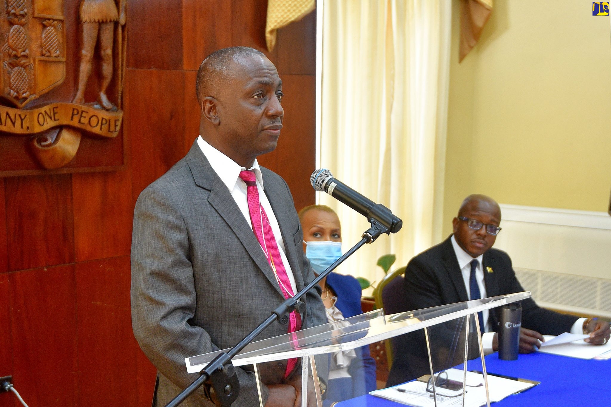 Executive Director of the National Solid Waste Management Authority (NSWMA), Audley Gordon (left),  addresses a virtual post-Cabinet press briefing on Wednesday (December 9). Also pictured at the head table (from left) are Minister of Education, Youth and Information, Hon. Fayval Williams; and Minister of Housing, Urban Renewal, Environment and Climate Change, Hon. Pearnel Charles Jr.