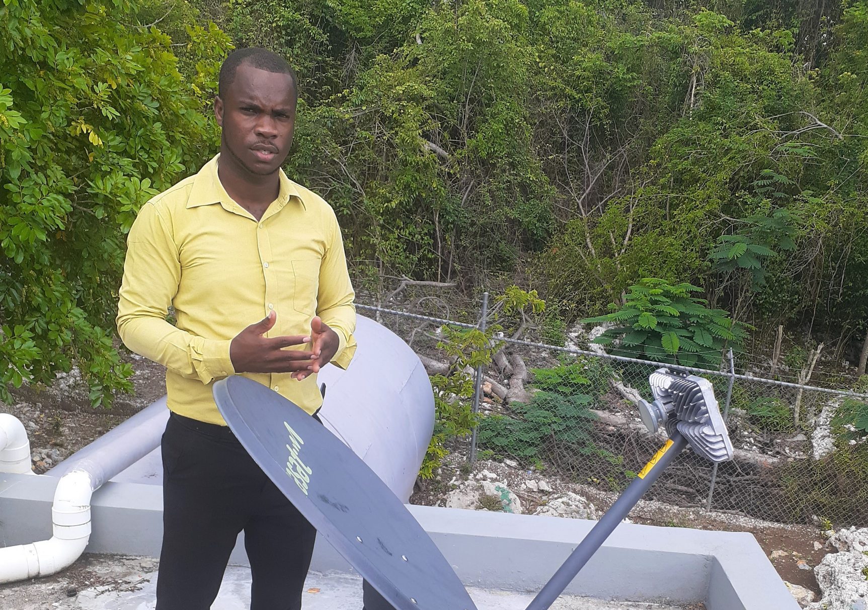 Principal of Little Bay Primary and Infant School in Westmoreland, Keron King, shows off the satellite dish, which powers the school’s Internet, provided by the Ministry of Education, Youth and Information through partnership with ReadyTV under its ReadyNet satellite Internet service.