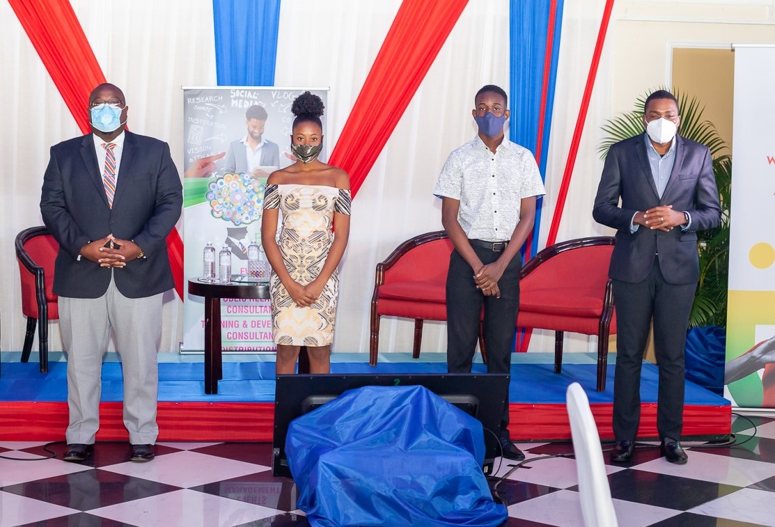 State Minister in the Ministry of Education, Youth and Information, Hon. Robert Morgan (right), and Pembroke Hall High School Principal, Rev. Claude Ellis (left), with John Maxwell Youth Leadership Scholars, Kierra Mullings and Nicholas Smith. Occasion was the John Maxwell Live2Lead Conference at Terra Nova Hotel in St. Andrew, last November, during which the inaugural scholarship awardees for Jamaica were announced. Minister Morgan was among the speakers at the event.

