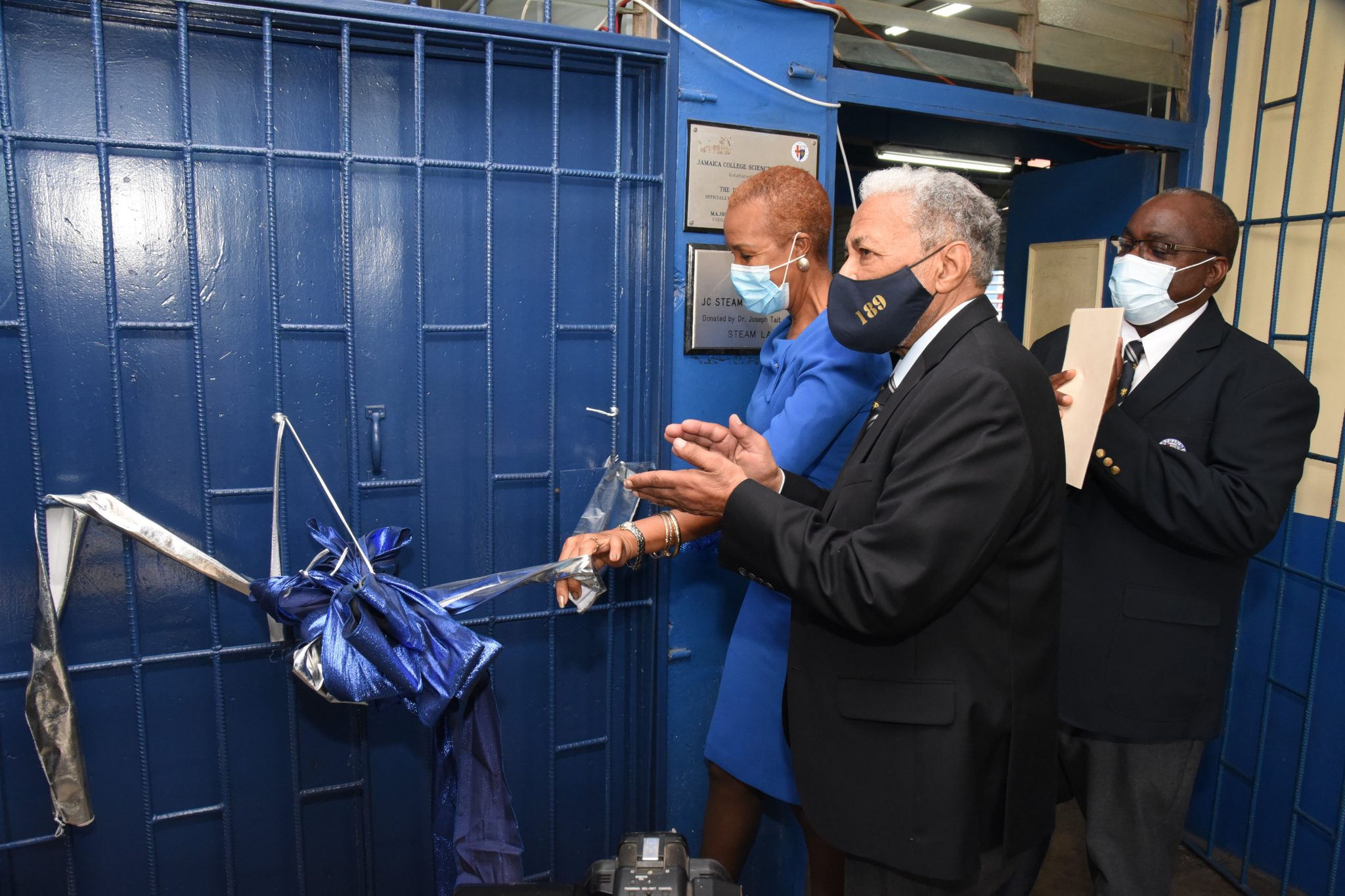 Minister of Education, Youth and Information, Hon. Fayval Williams (left), cuts the ribbon to officially open the STEAM Laboratory that was donated by Jamaica College Old Boy, Veterinarian, Dr. Joseph Tait, during a ceremony held at Jamaica College, Wednesday (January 27).  Sharing the moment (from second left) are Dr. Tait and Principal at Jamaica College, Wayne Robinson.