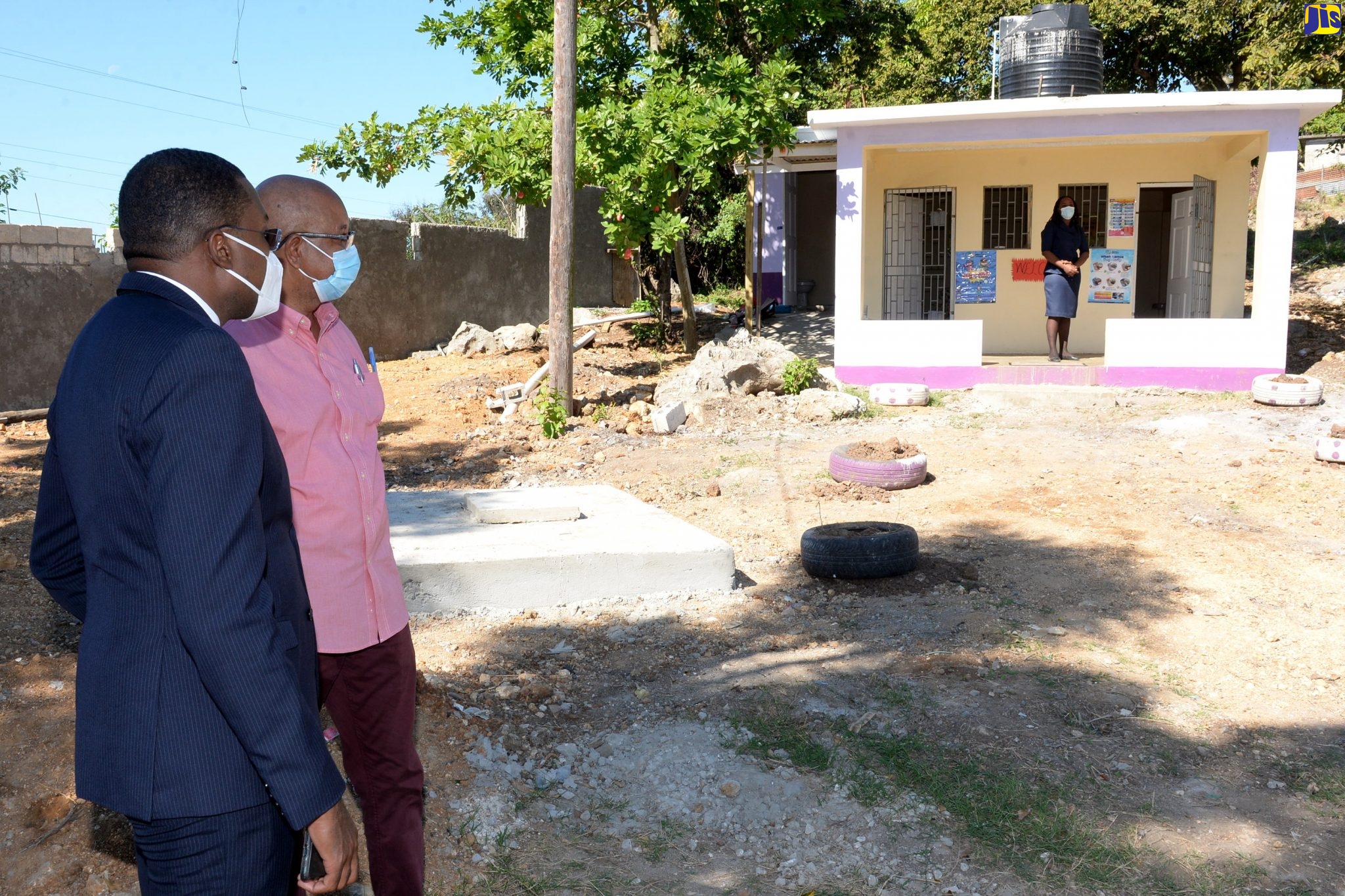 State Minister in the Ministry of Education, Youth and Information, Hon. Robert Morgan (left), in discussion with Chairman of the Board of Crescent Primary School in Spanish Town, St. Catherine, Councillor Norman Scott, while viewing the isolation unit at the school, recently.