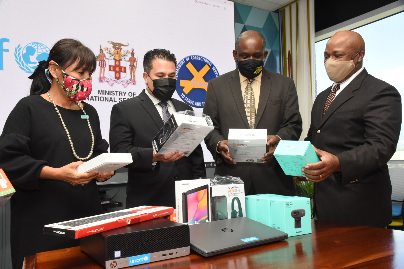 Minister without Portfolio, Ministry of National Security, Senator the Hon. Matthew Samuda (second left), looks at the assortment of technological items donated by the United Nations Children’s Fund (UNICEF) to benefit children in juvenile facilities. The handover ceremony was held at the Ministry’s Oxford Road offices in Kingston on Wednesday (January 20).  Others (from left) are: Country Representative, UNICEF Jamaica, Mariko Kagoshima; Permanent Secretary in the Ministry, Courtney Williams; and Commissioner of Corrections, Lieutenant Colonel (retired), Gary Rowe. 

