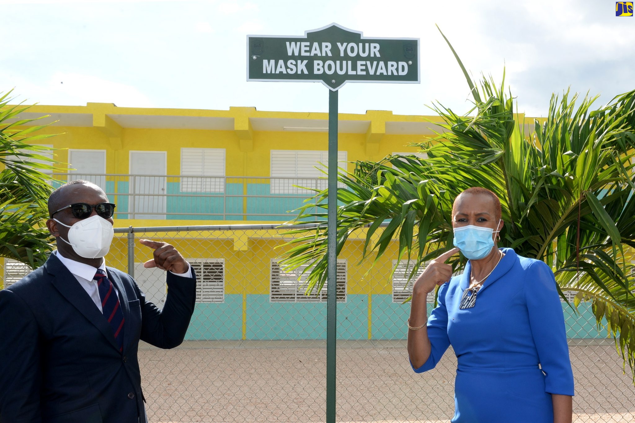 Minister of Education, Youth and Information, Hon. Fayval Williams (right), and Principal of the Marlie Mount Primary and Infant School, in St. Catherine,  Calvin Harris, highlight one of the new signs erected at the new 10-classroom block that was opened on January 14.