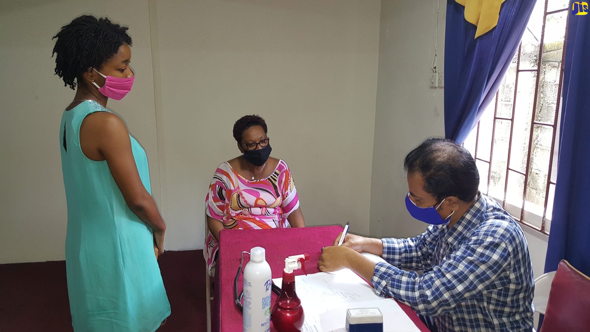 Dr. Sridhar Shankar (right), attends to patients Jade Cohall-Cunningham (centre) and Lorna Cohall at a medical camp at the Faith Temple Assembly of God church in Montego Bay, St. James, on January 31. The parish hosted one of the 14 medical camps that took place on January 31 in nine parishes, sponsored by the Indian High Commission.