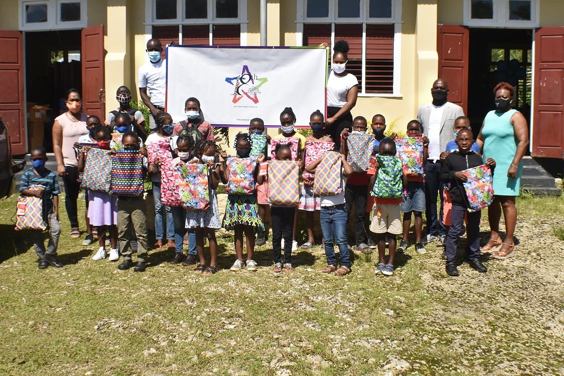  Students of the Portland-based Nonsuch Primary School, show off gift packages donated by the Green Block Foundation, recently.  Sharing the moment are Co-Founder of the Foundation, Conroy Blake (second right);Principal of the school, Marlise Aidiansingh (right);  and staff.

 