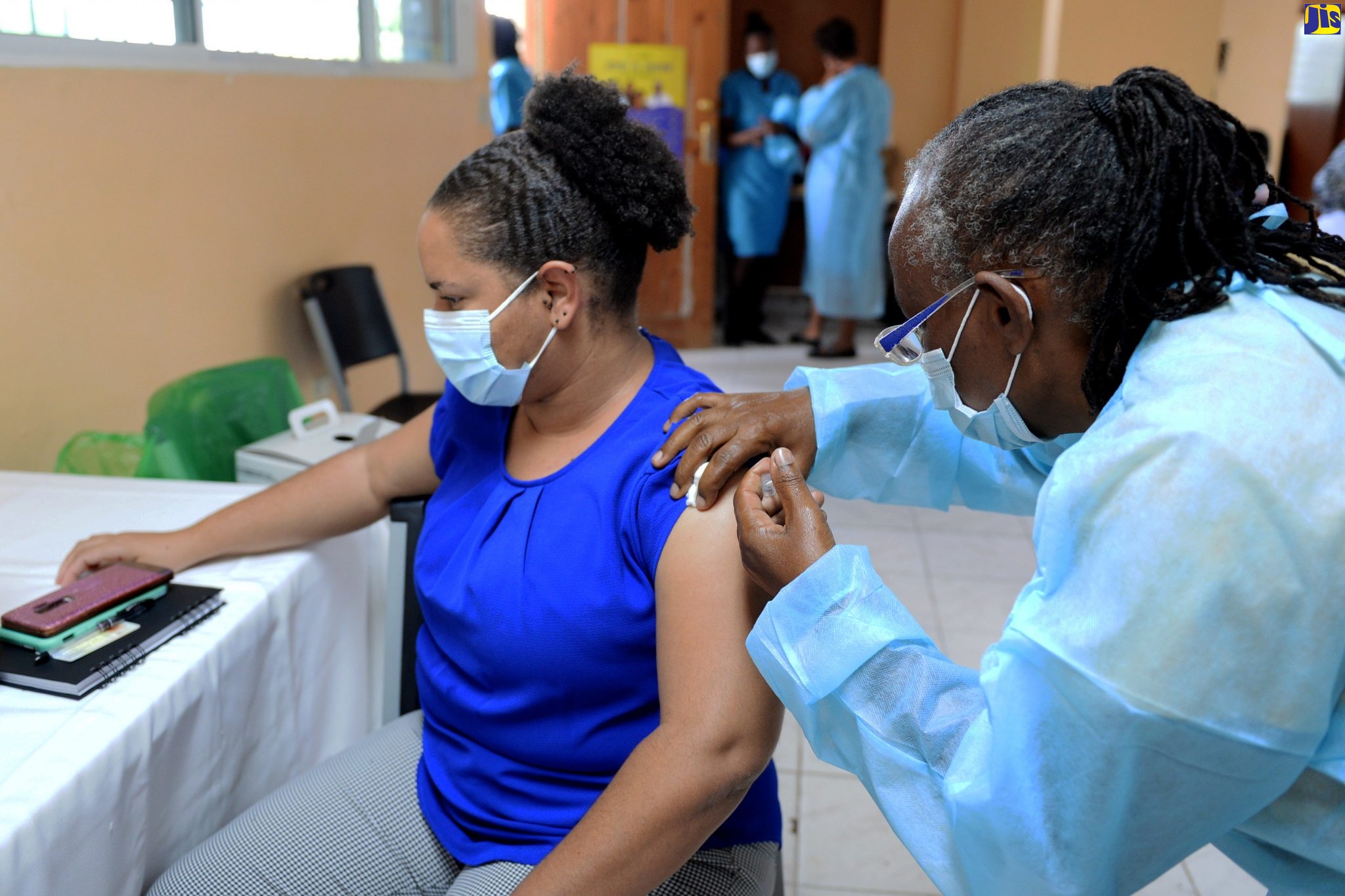 Head of the X-Ray Department at the Spanish Town Hospital Dr. Olivia Lee-Reid, receives the COVID -19 vaccine from Public Health Nurse Lavern Daley, at the health facility on Wednesday (March 10).