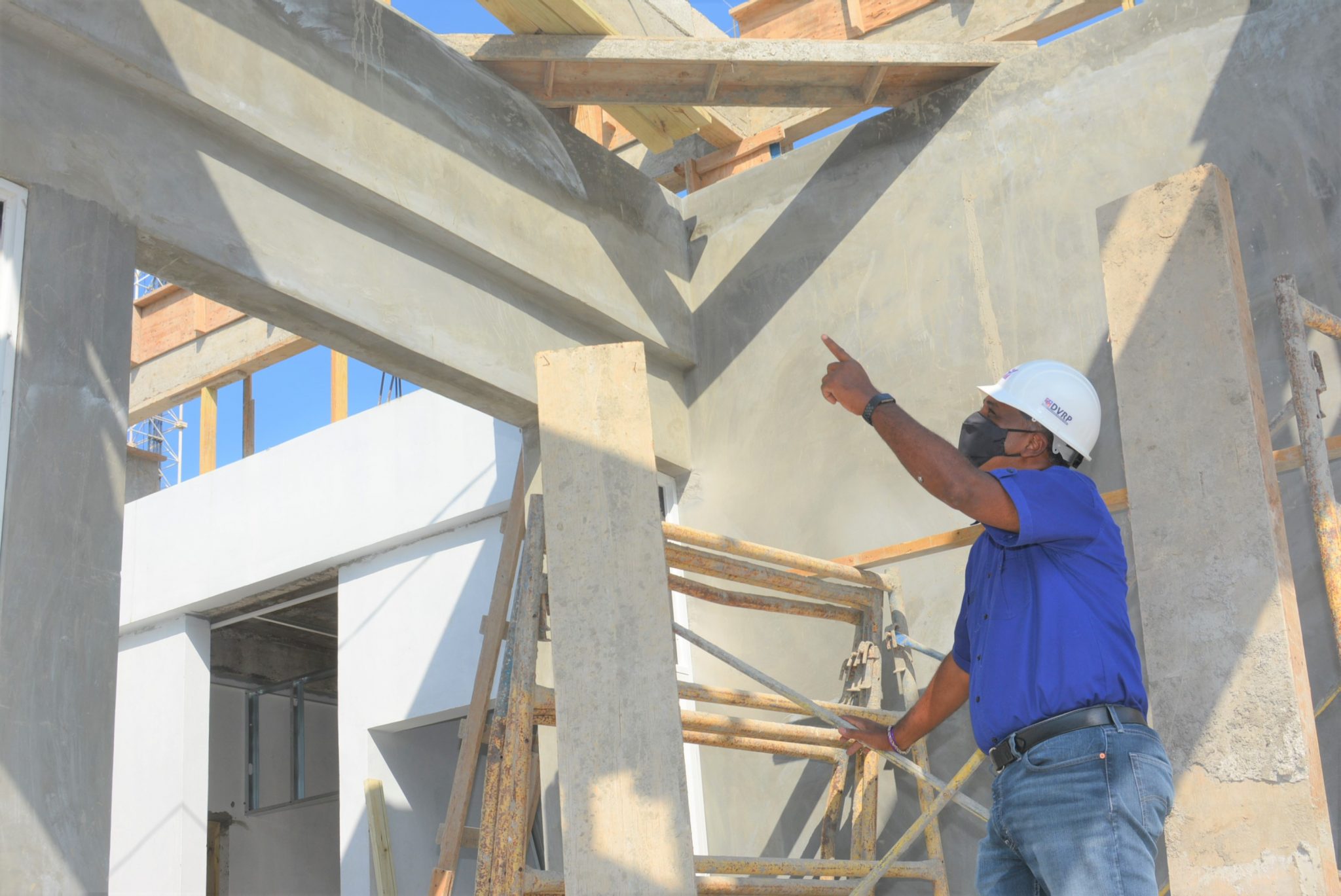 Managing Director of the Jamaica Social Investment Fund (JSIF), Omar Sweeney, points to a section of the new Mount Salem Police Station building in St. James, under construction, during a walk-through of the facility on March 19.