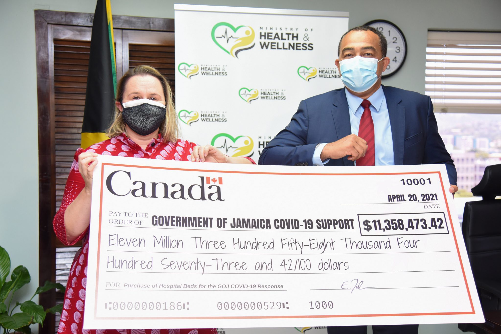 Minister of Health and Wellness, Dr. the Hon. Christopher Tufton (right), and Canadian High Commissioner, Her Excellency, Emina Tudakovic, hold a symbolic cheque of Can$100,000, representing one element of the Government of Canada’s support to the Government of Jamaica’s fight against the COVID-19 pandemic. The presentation was made during a courtesy call at the Ministry’s New Kingston offices on April 20.