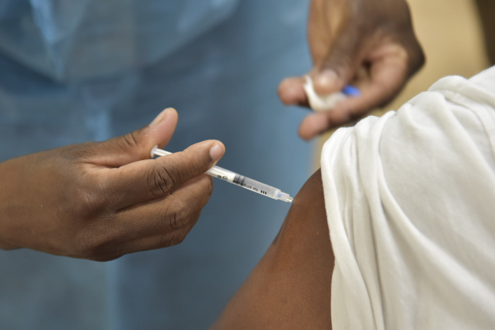 A nurse administers a coronavirus (COVID-19) vaccine to a member of the public. 
